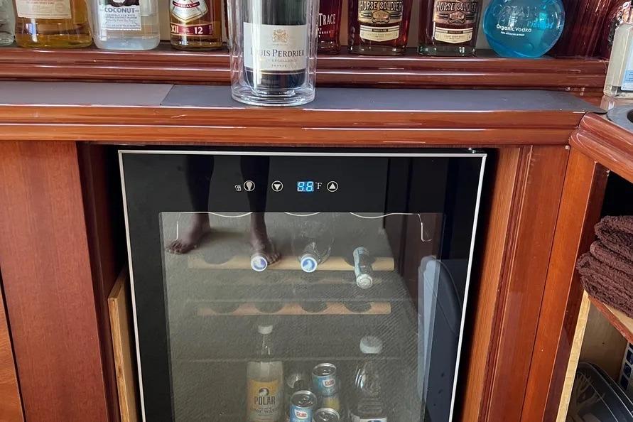 Luxury yacht bar with wine cooler and assorted spirits, Lazzara SC Motor Yacht 2004.