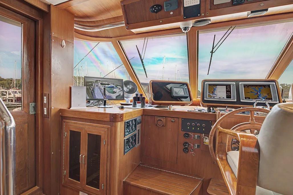 Interior helm of 1989 Jefferson Marquessa 63 yacht with navigation equipment and wooden finishes.