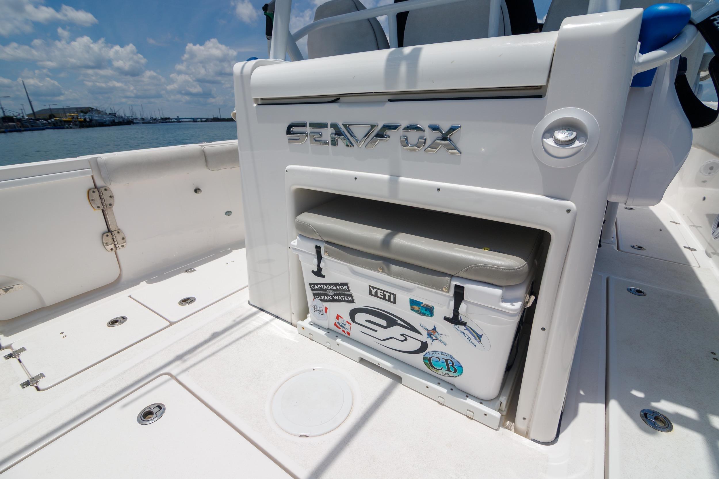 2021 Sea Fox 328 Commander boat deck with cooler, under clear blue sky.