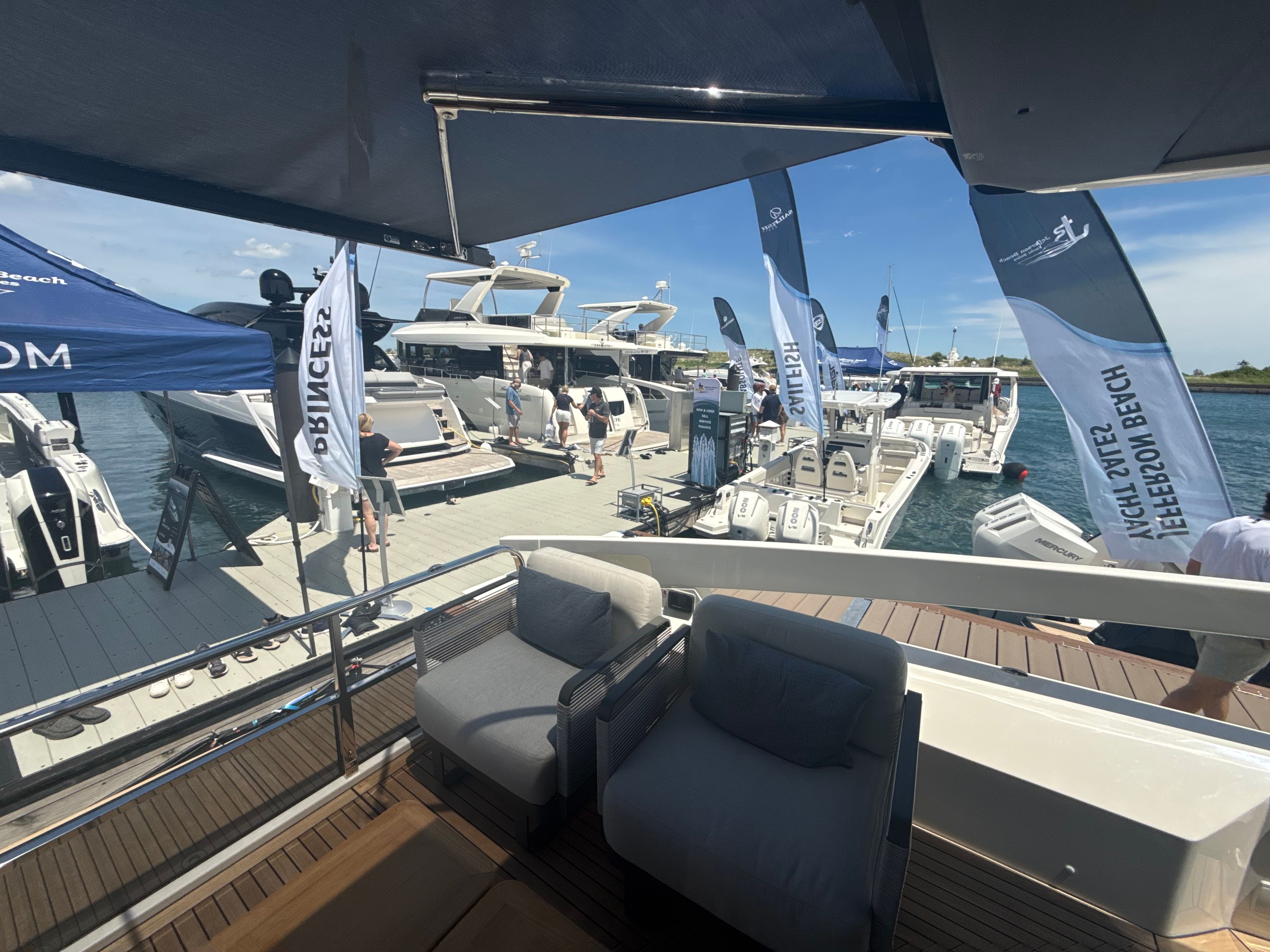 A 2010 Sea Ray Sundancer 310 is docked in a sunny marina alongside other boats.
