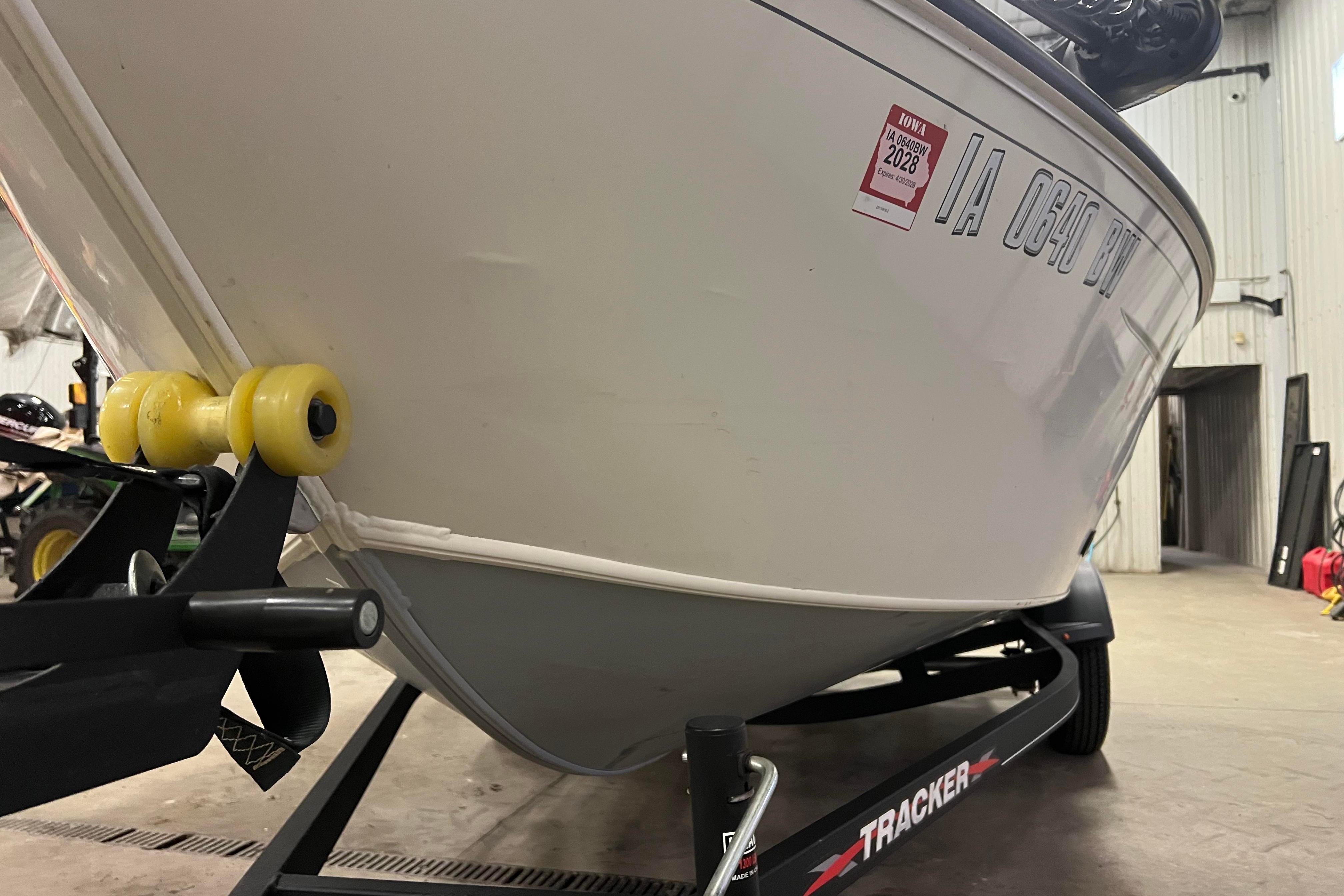 2022 Tracker Pro Guide V-16 WT boat on trailer in indoor storage.