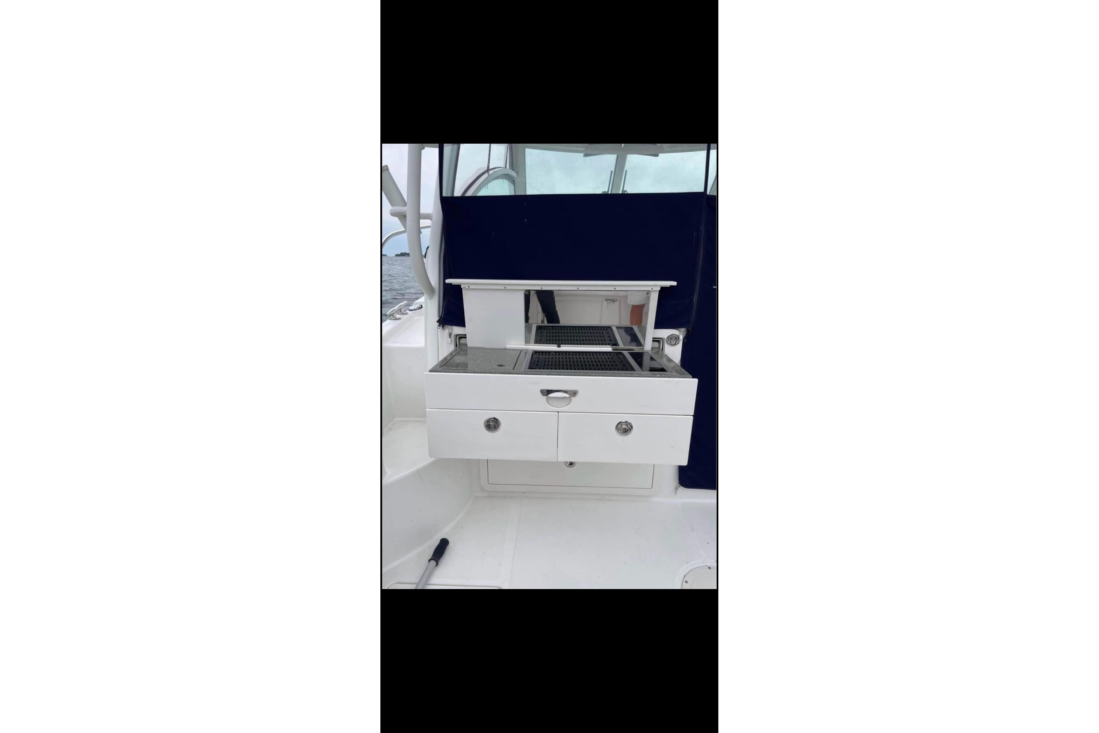 2013 Boston Whaler 315 Conquest boat grill station with storage drawers.