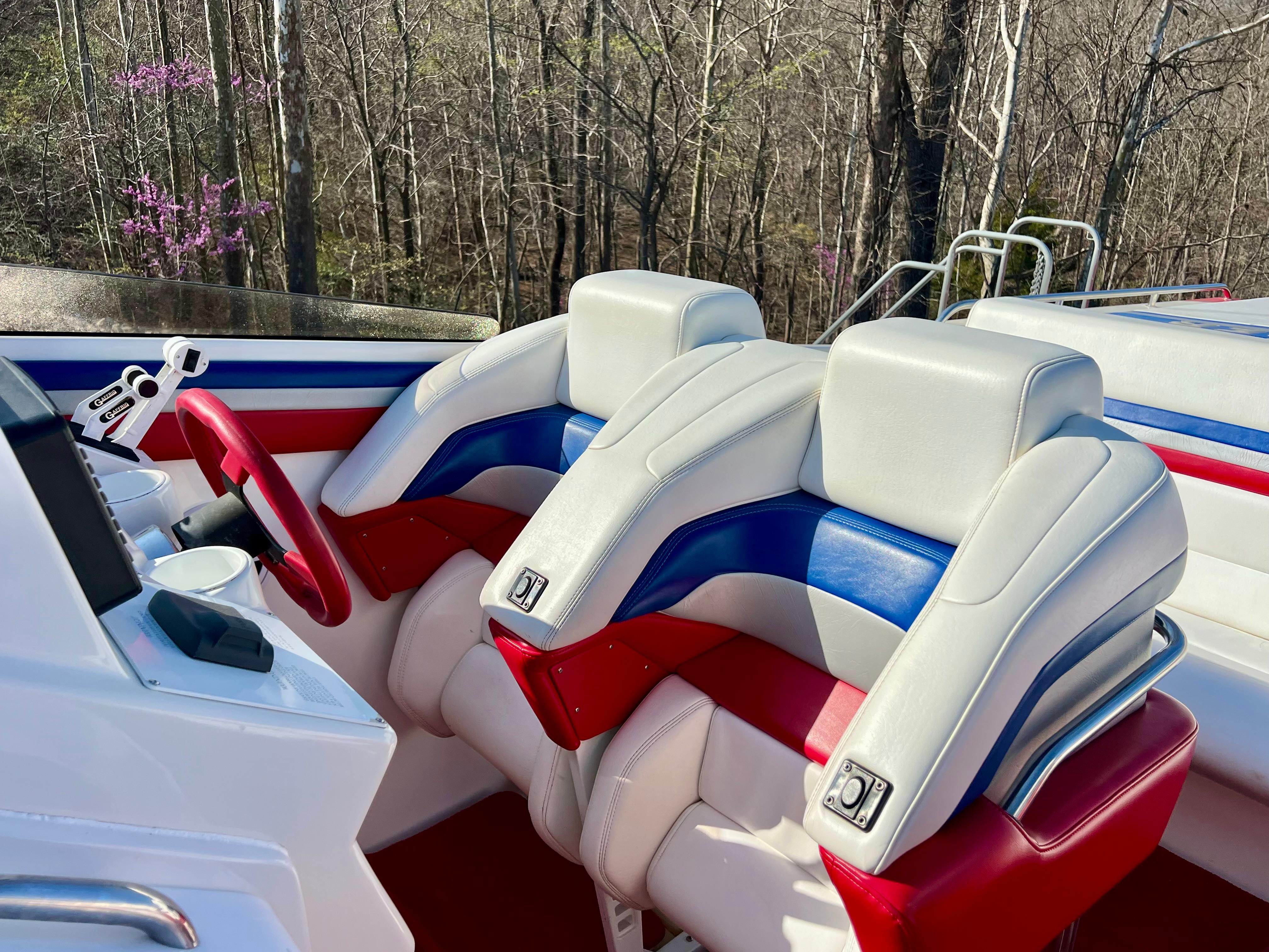 Interior of 1999 Black Thunder 430 Flat Deck with red, white, and blue seating.