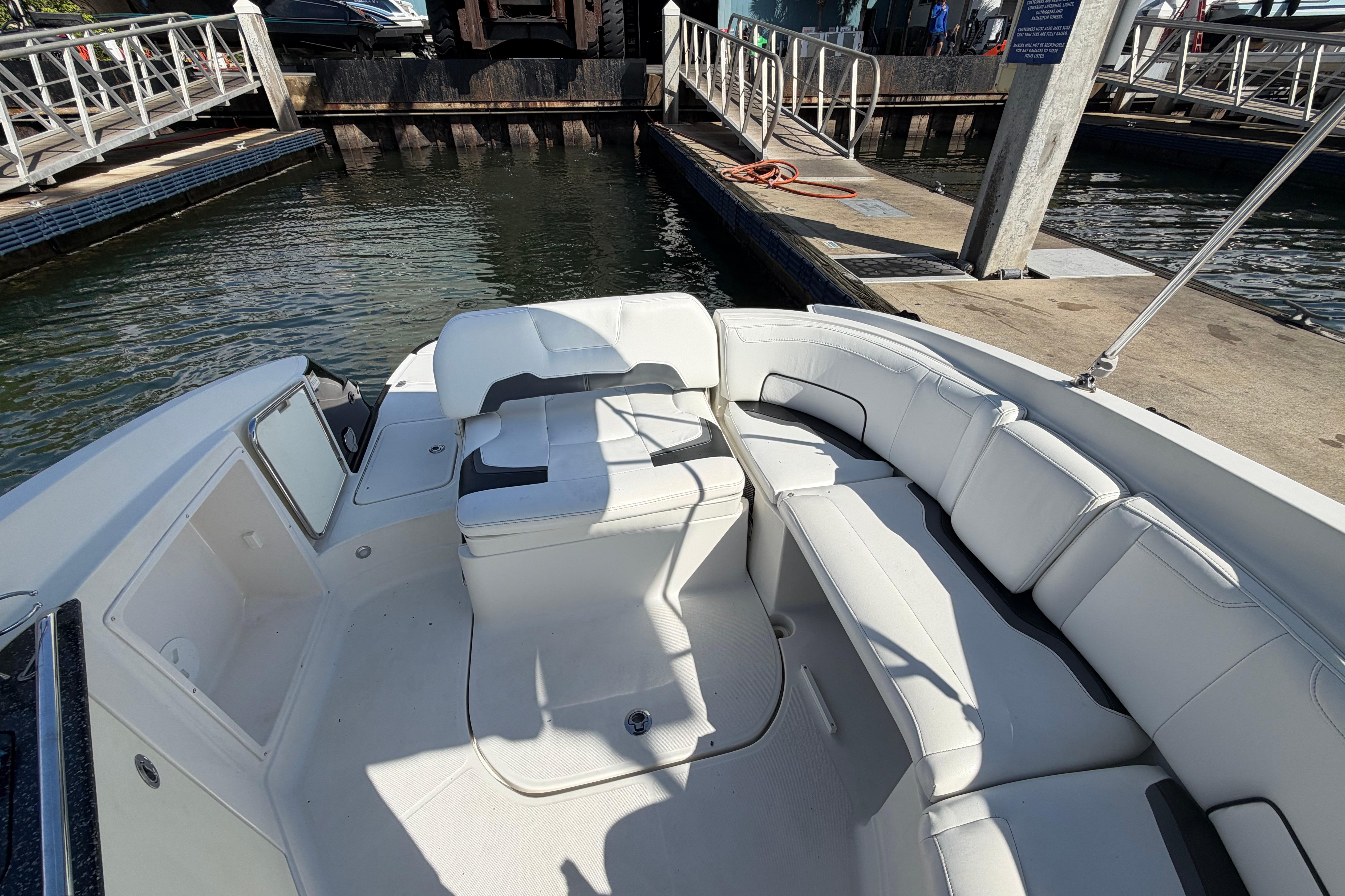 2015 Monterey 264FS boat interior with white seating at a dock.
