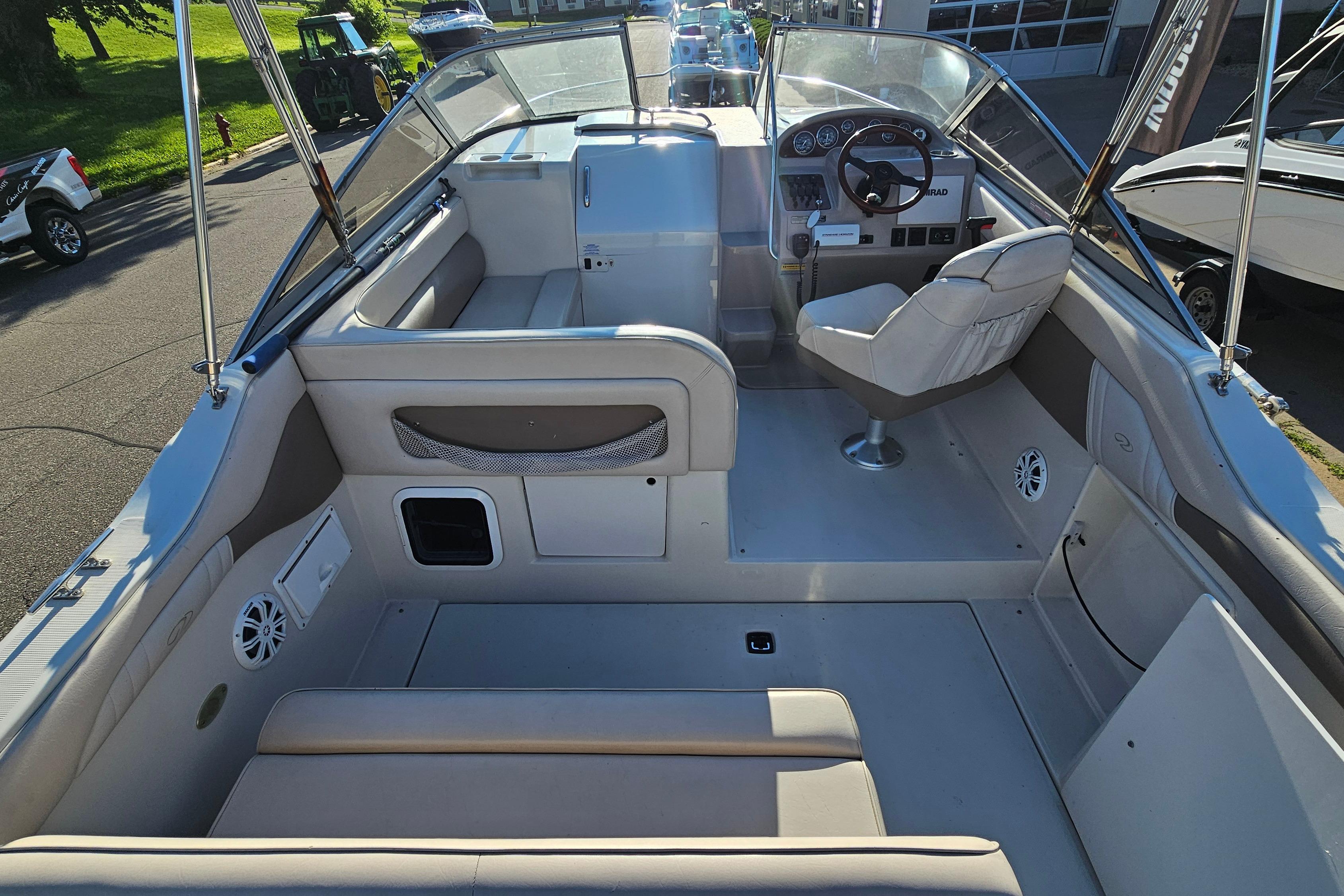 Interior of a 1999 Regal Commodore 258 boat, featuring seating and steering console.