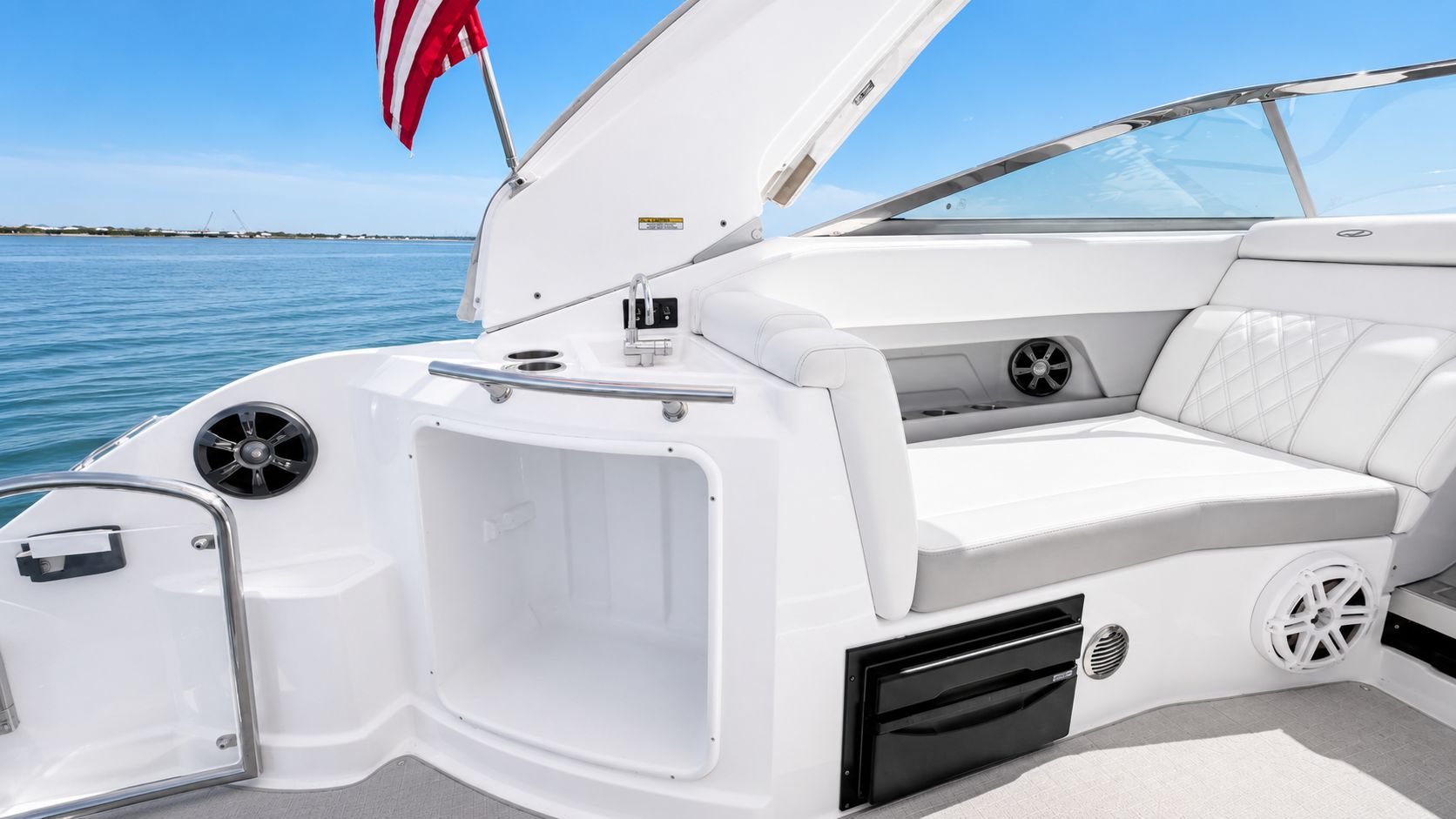 The image shows the cockpit of a 2020 Regal 28 Express with white seating and a refrigerator.