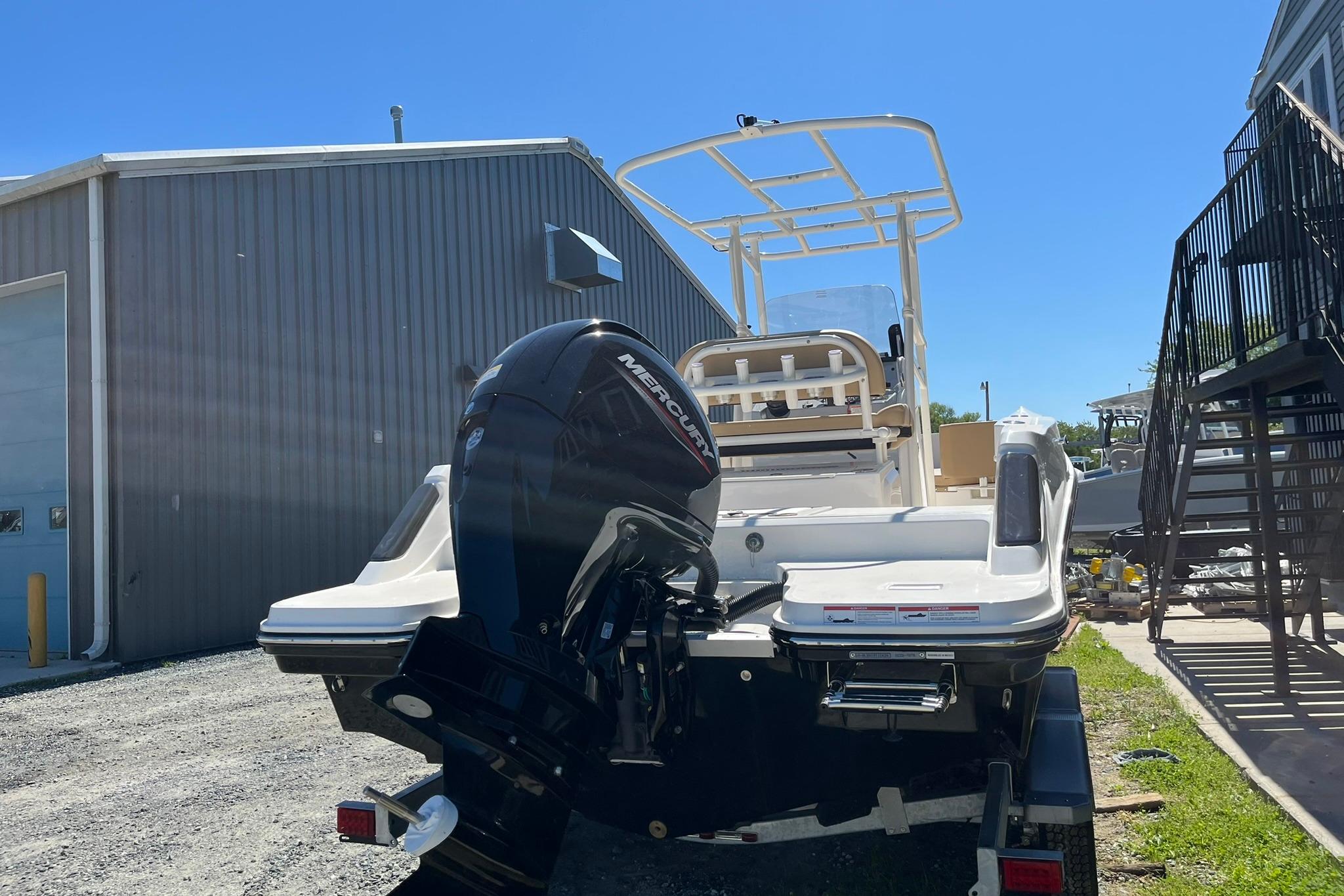 2026 Bayliner Trophy T22CC boat with Mercury outboard motor, parked outdoors.