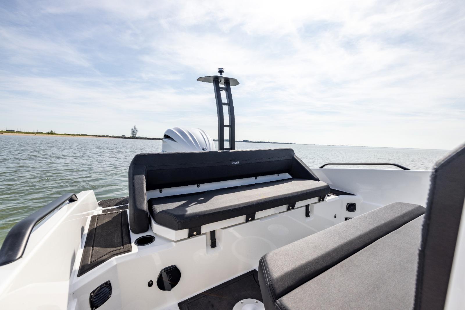 Modern Iron 707 boat interior with sleek seating, 2022 model, on calm water.