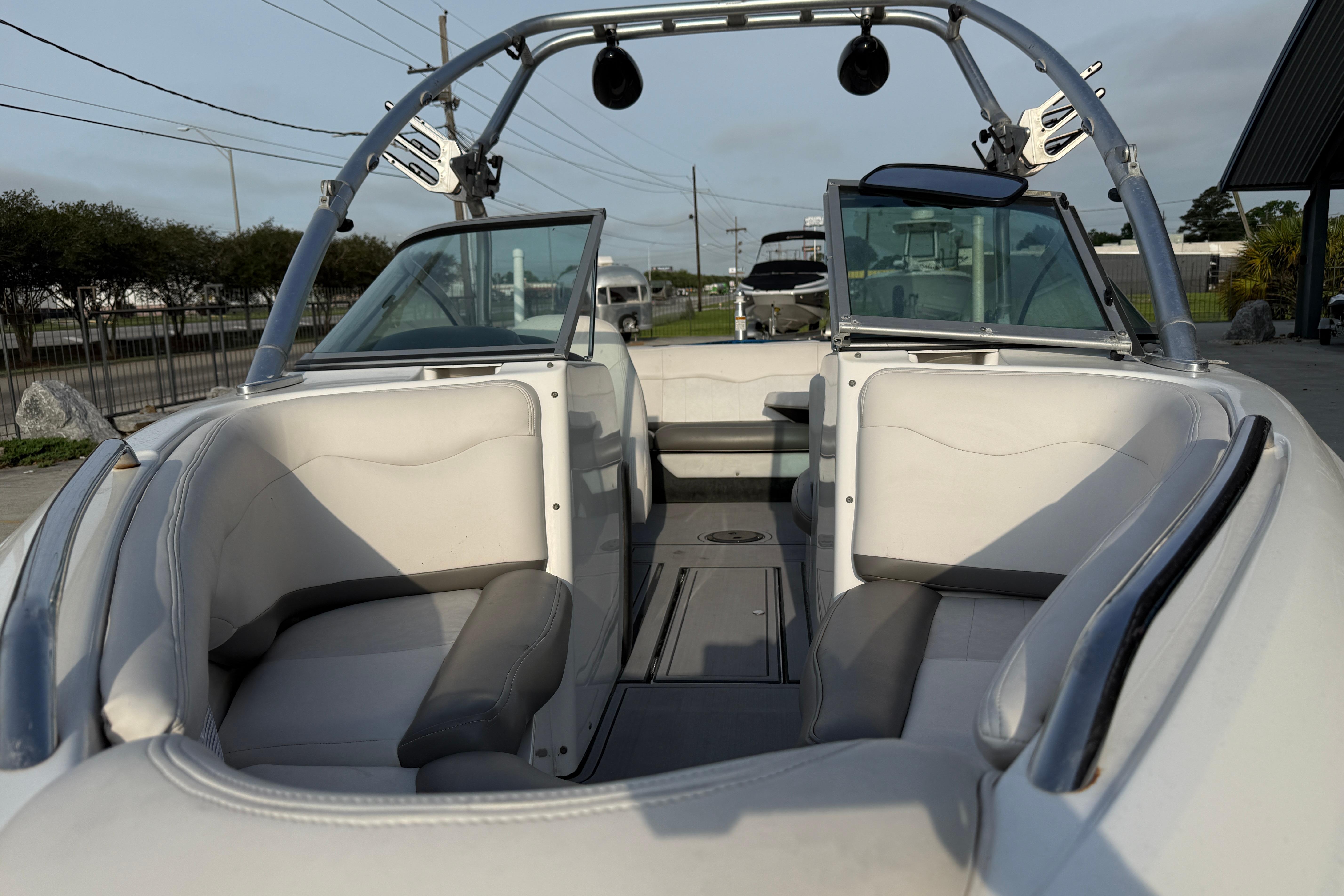 2005 MasterCraft X10 boat interior with white seating and open windshield.