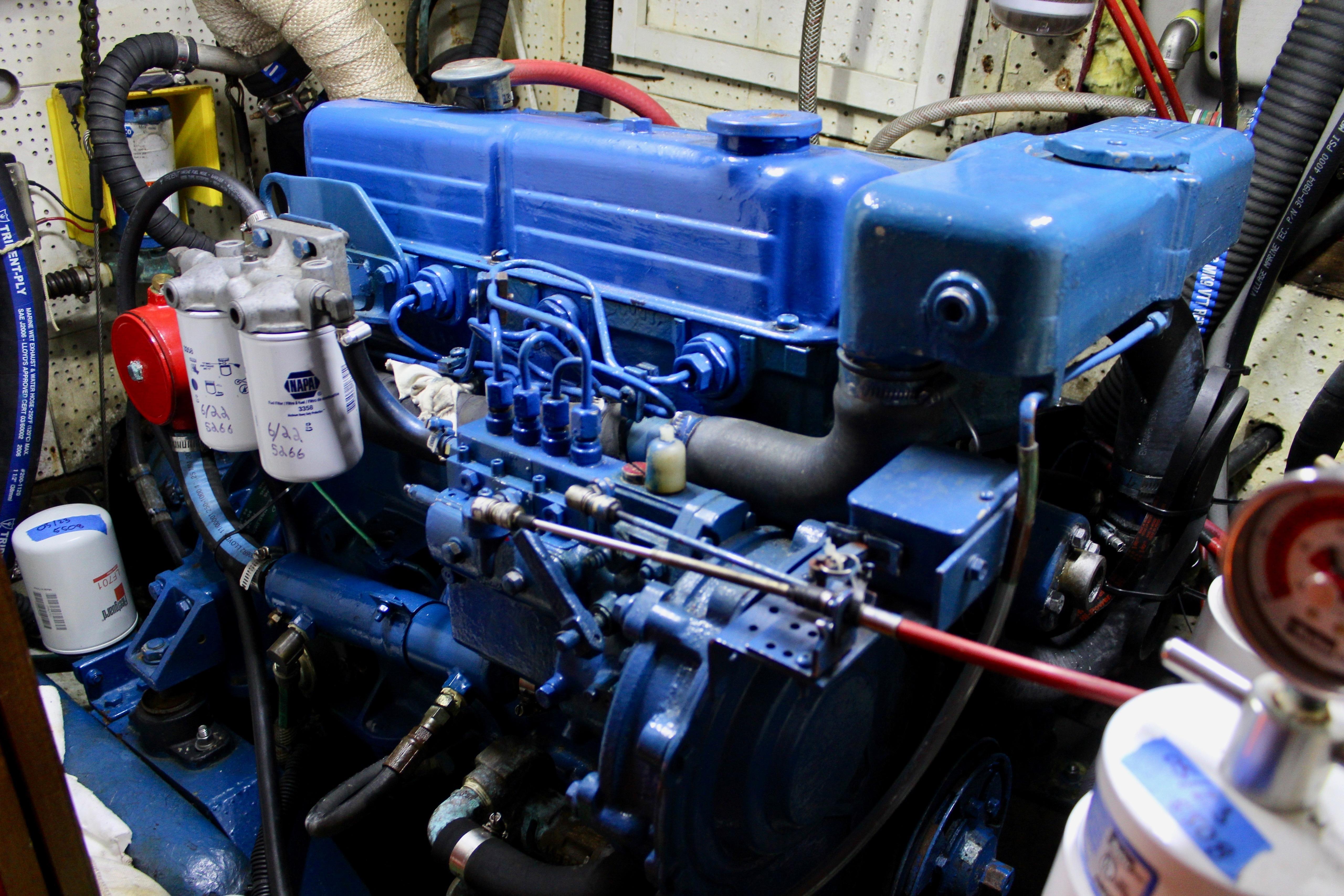 Engine room of a 1981 Kelly Peterson 46 yacht, featuring a blue marine engine.