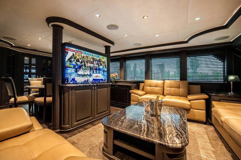 Luxurious interior of 2014 Fifth Ocean Yachts 24m Explorer Yacht with leather seating and marble table.