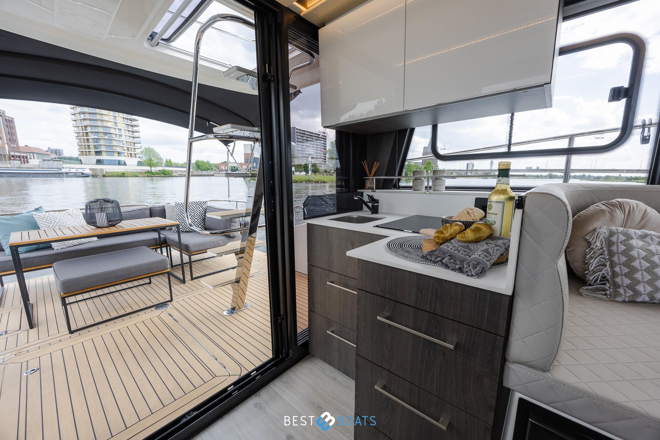 Luxurious interior of 2023 Cobra Yachts Futura 36 Premium Fly with modern kitchen and outdoor seating.