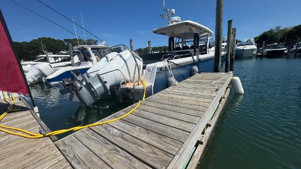 Nimbus T11 2025 boat docked at marina, clear blue sky, calm water.
