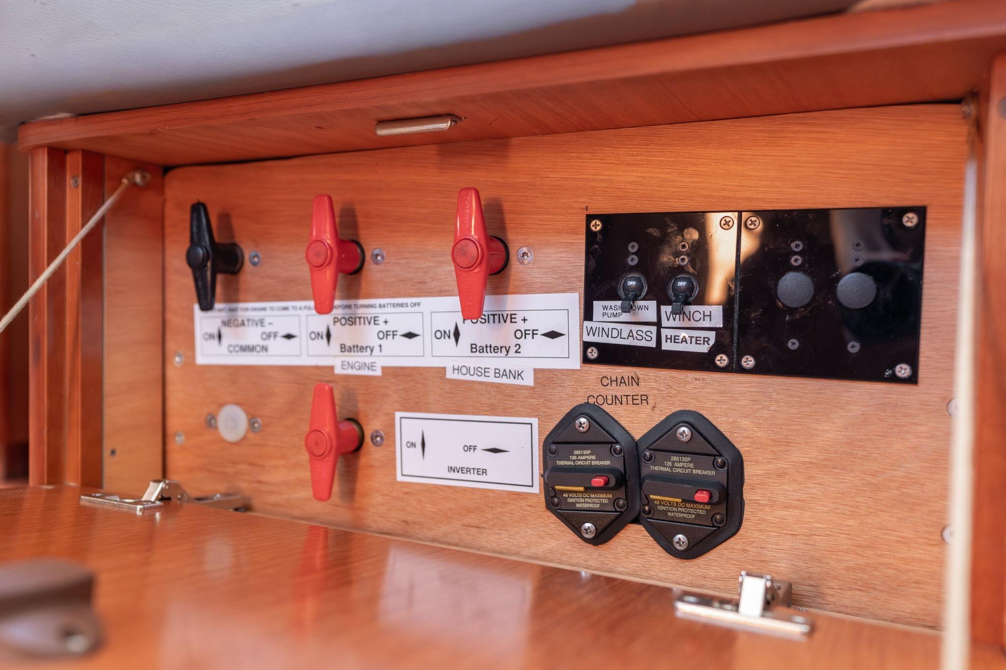 Electrical control panel on a 2013 Beneteau Oceanis 50 yacht, featuring switches and circuit breakers.