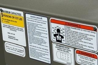 Warning labels on 2025 Tracker Grizzly 2072 Utility boat, detailing safety and capacity information.