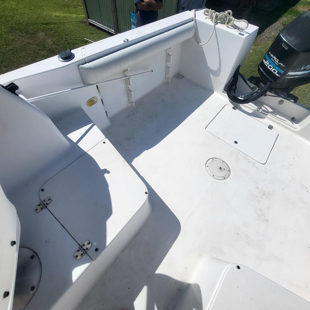 The image shows the cockpit of a 1998 Sport-Craft 211WAC boat with an outboard motor.