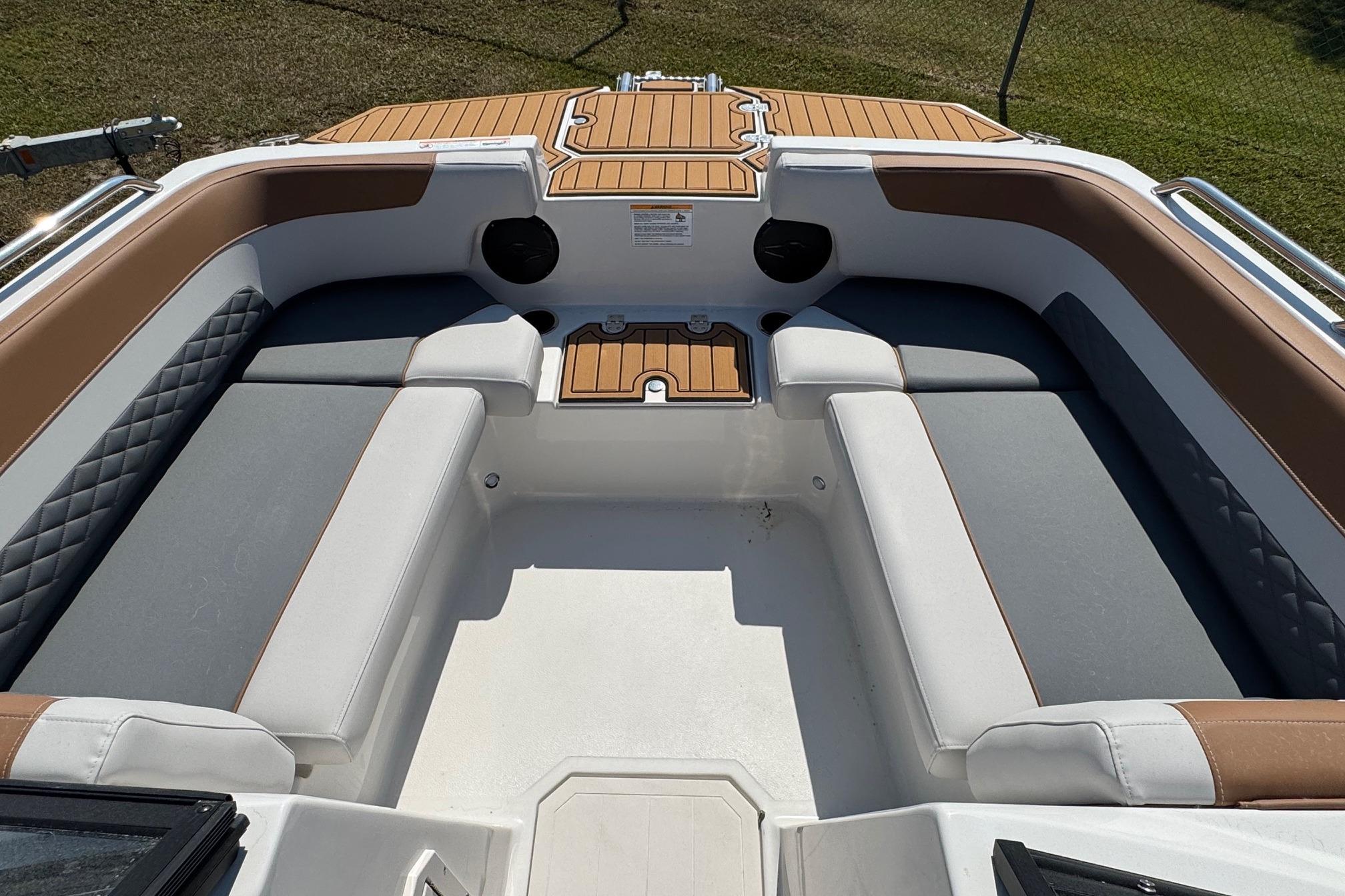 2026 Starcraft SVX 190 OB boat interior with cushioned seating and wood accents.