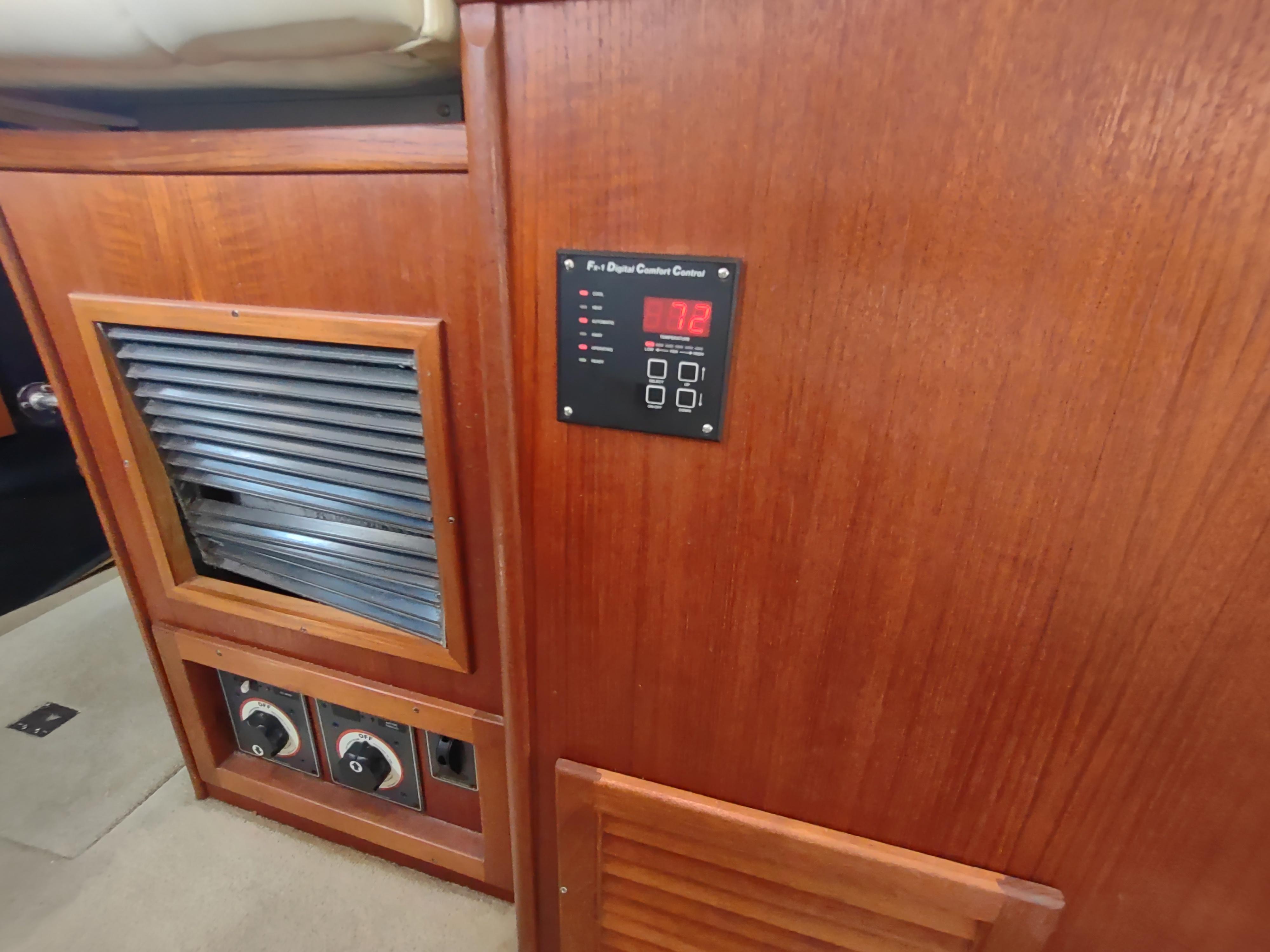 Control panel and wooden cabinetry inside a 2003 American Tug 34 boat.
