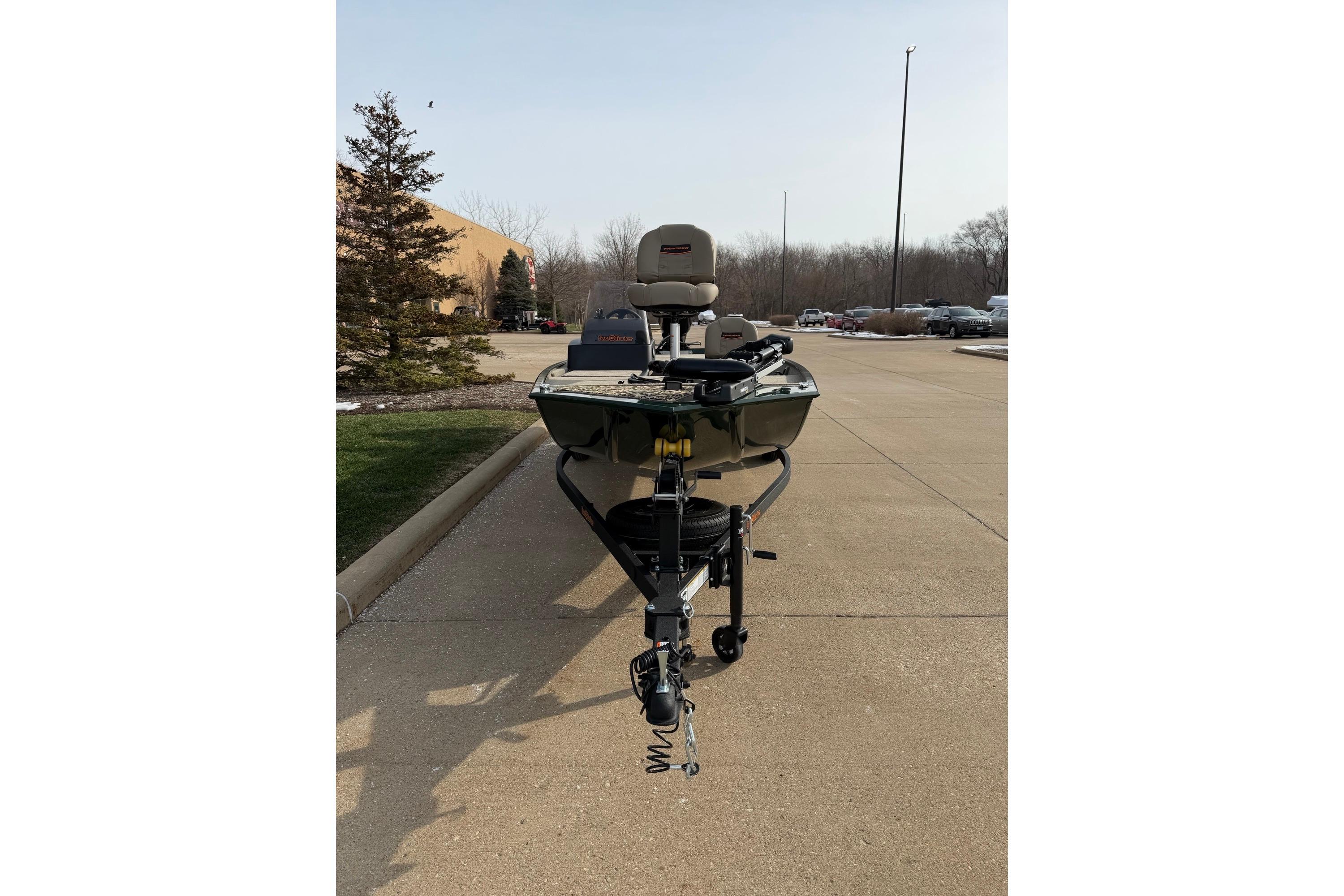 2026 Tracker Bass Tracker Classic Limited boat on a trailer in a parking lot.