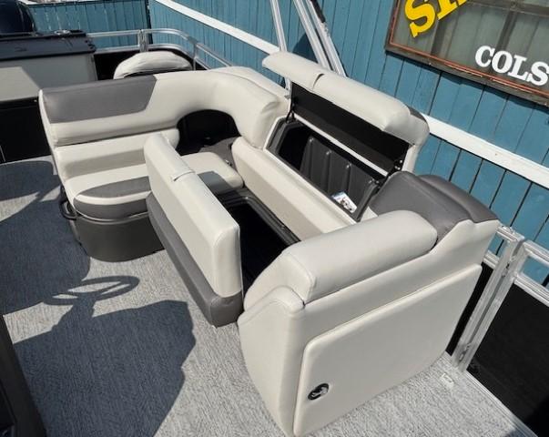 2026 Sun Tracker Fishin' Barge 20 DLX interior with gray seating and storage compartments.