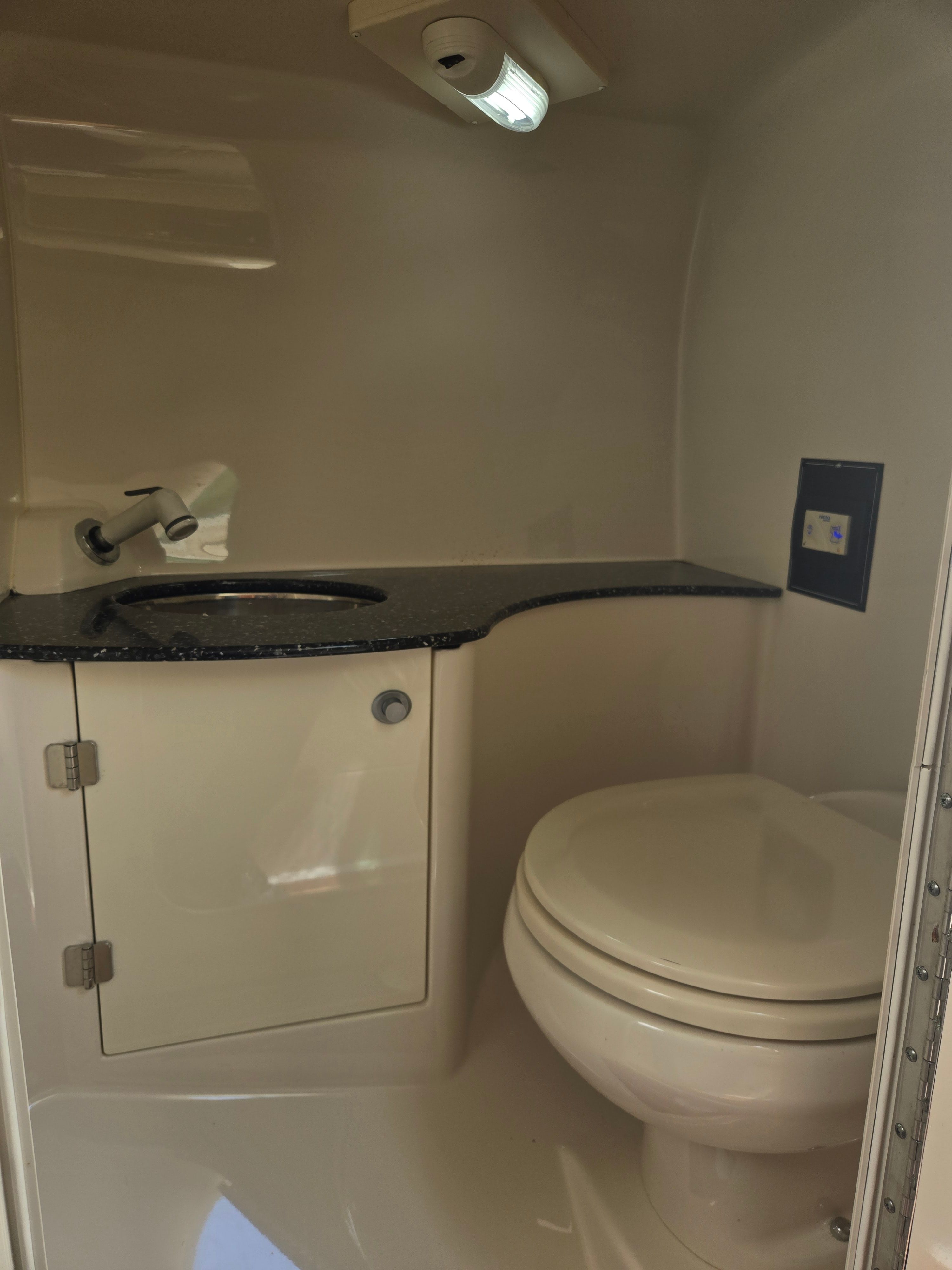 Interior view of a boat bathroom with a sink and toilet.