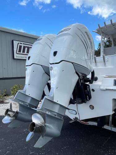 2014 Everglades 325 Center Console with dual outboard motors, docked outdoors.