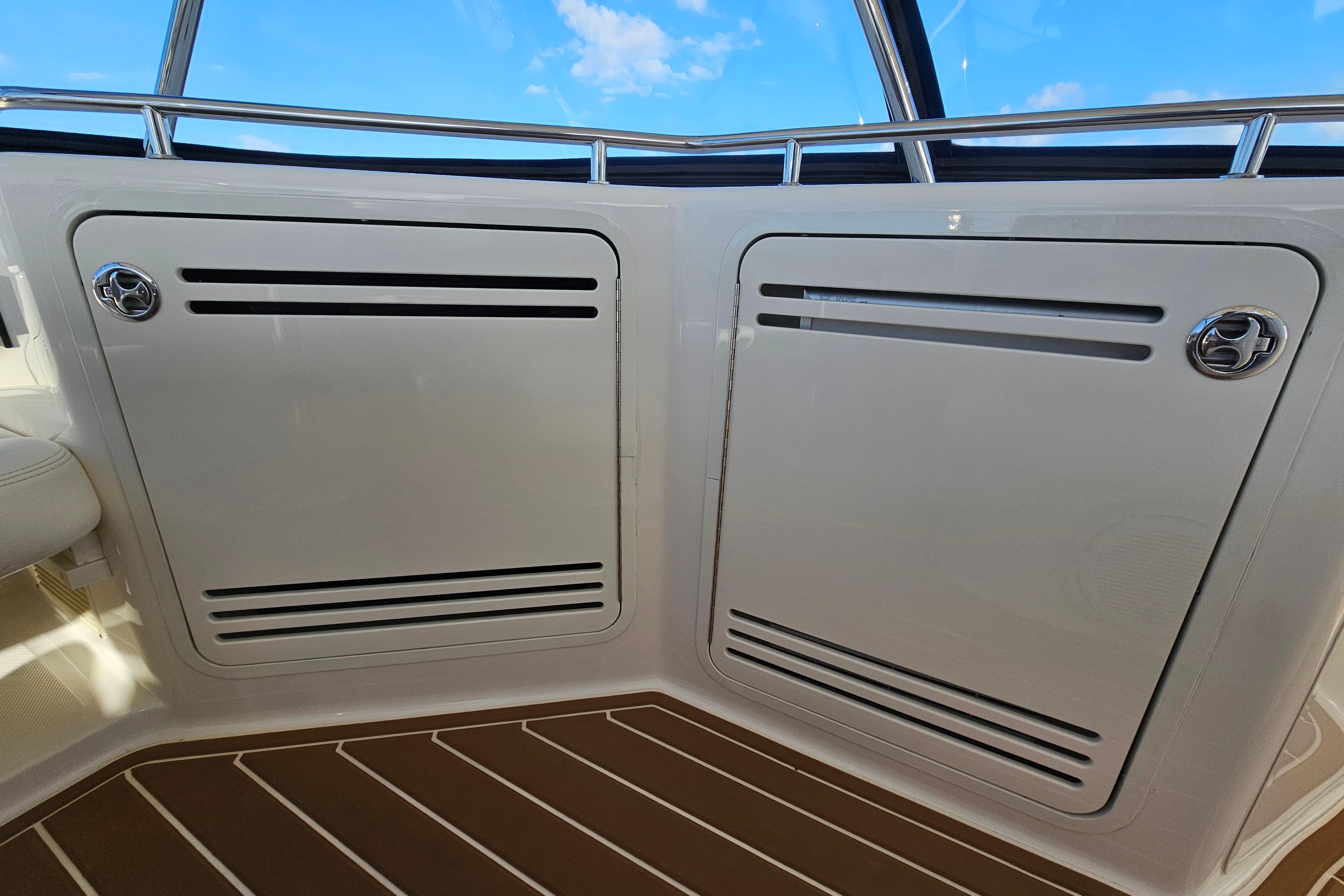 2006 Sea Ray 580 Sedan Bridge interior with sleek white paneling and stainless steel accents.