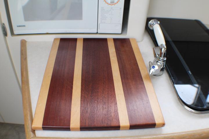 Cutting board on Bayliner 2655 Ciera Sunbridge 1998 kitchen counter, near microwave and faucet.