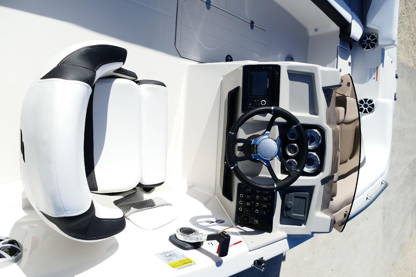 2026 Starcraft SVX 211 OB boat interior with steering wheel and seating.