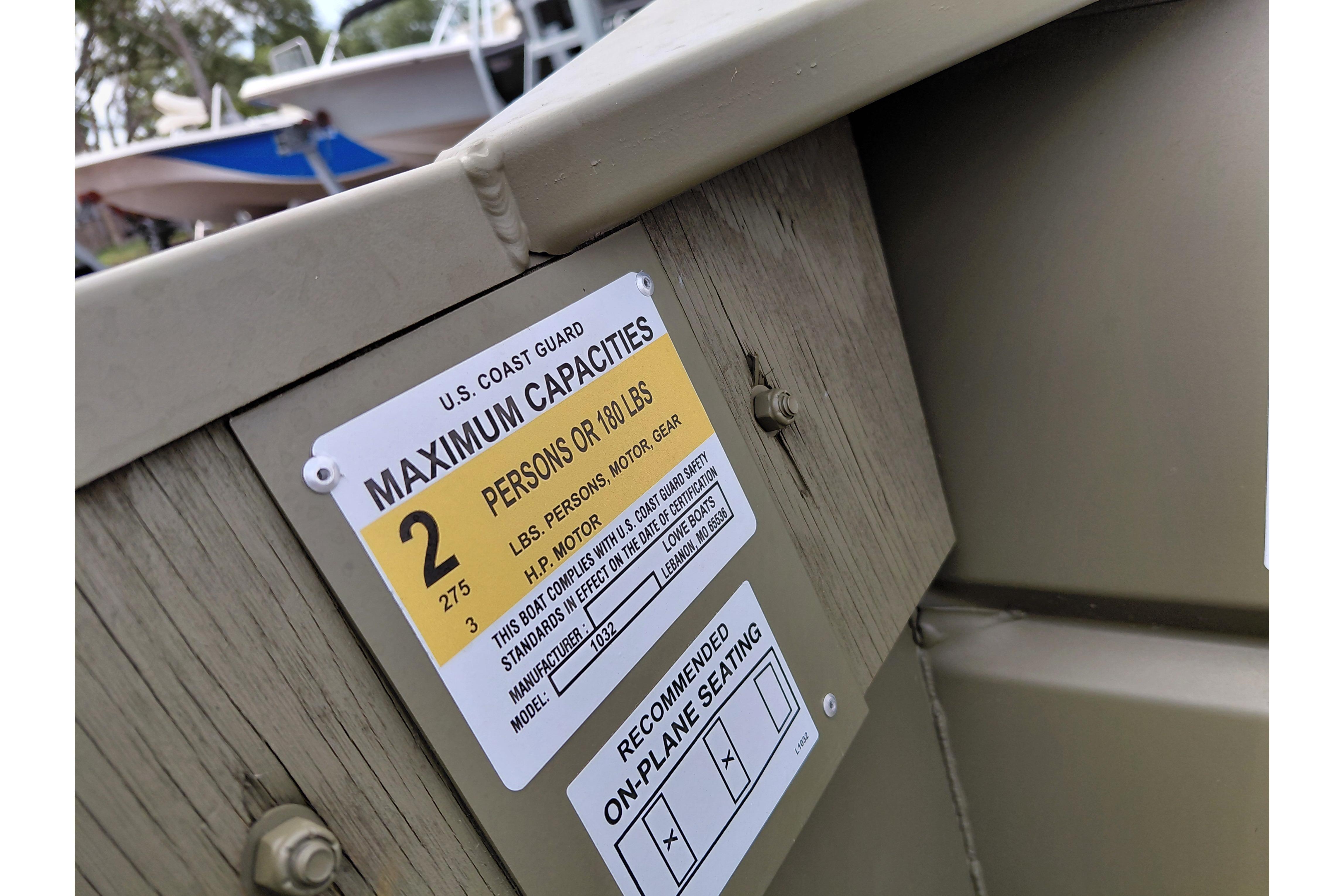 2026 Lowe L1032 Jon boat capacity label, showing maximum capacity of two persons or 180 pounds.