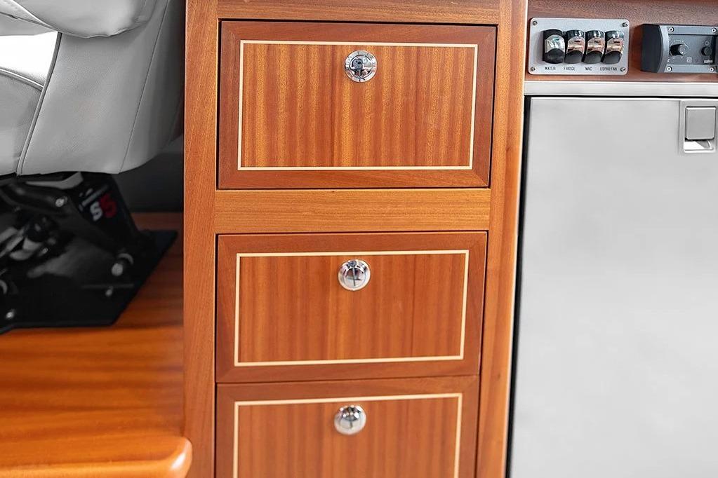 Wooden cabinet drawers in a 2026 KingFisher 3225 GFX Offshore boat interior.