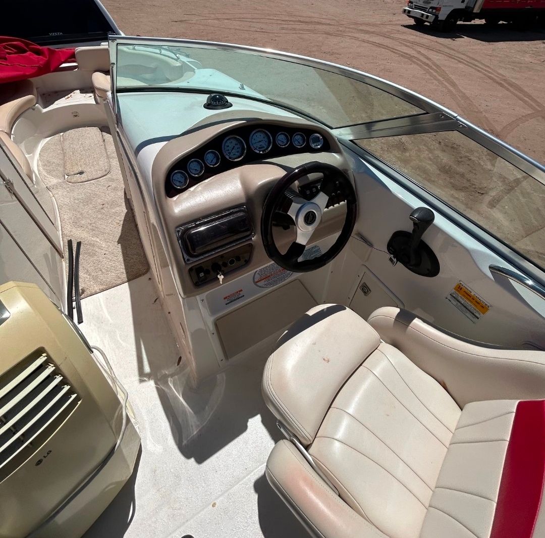 Interior of a 2001 Chaparral Sunesta 233 boat with steering console.