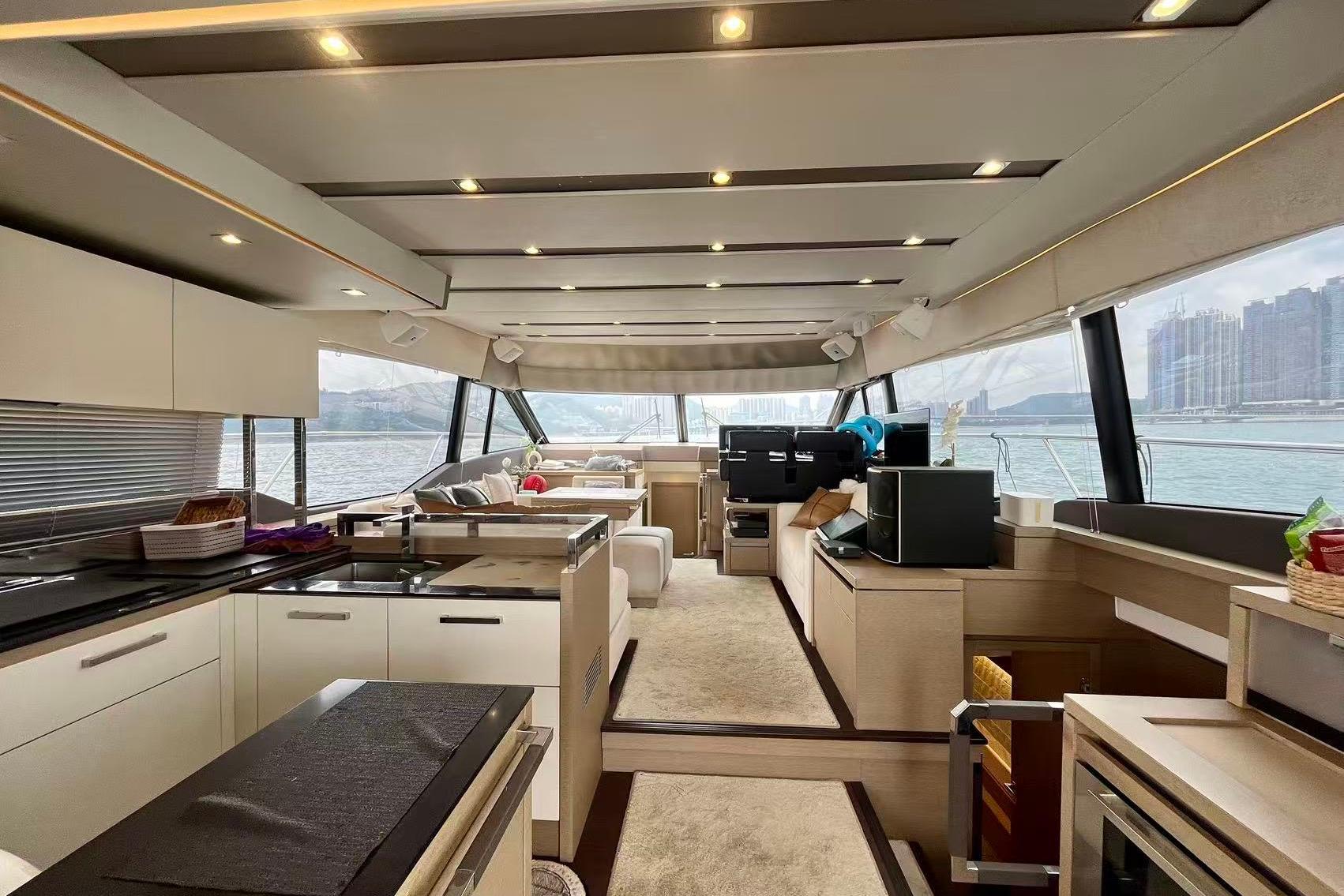 Luxurious interior of a 2019 Prestige 630 yacht with modern kitchen and scenic views.