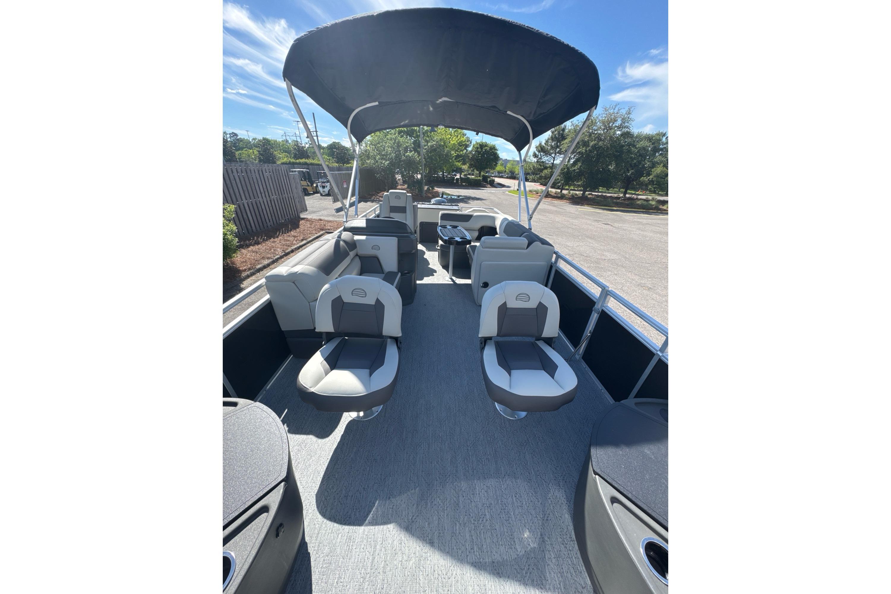 2026 Sun Tracker Fishin' Barge 20 DLX pontoon boat with spacious seating and canopy.