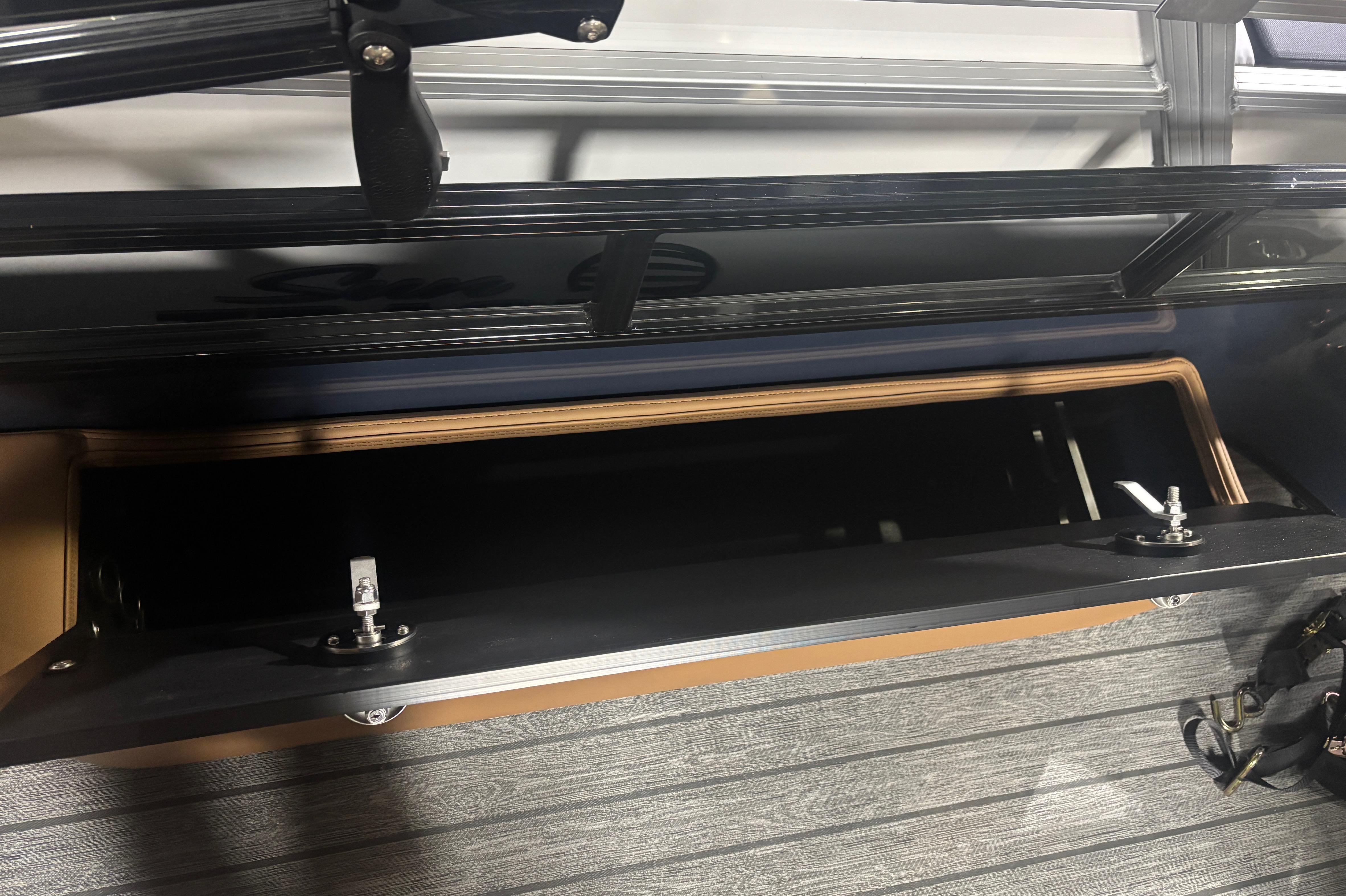 Open storage compartment on 2026 Ranger 223F boat, featuring sleek design and durable materials.