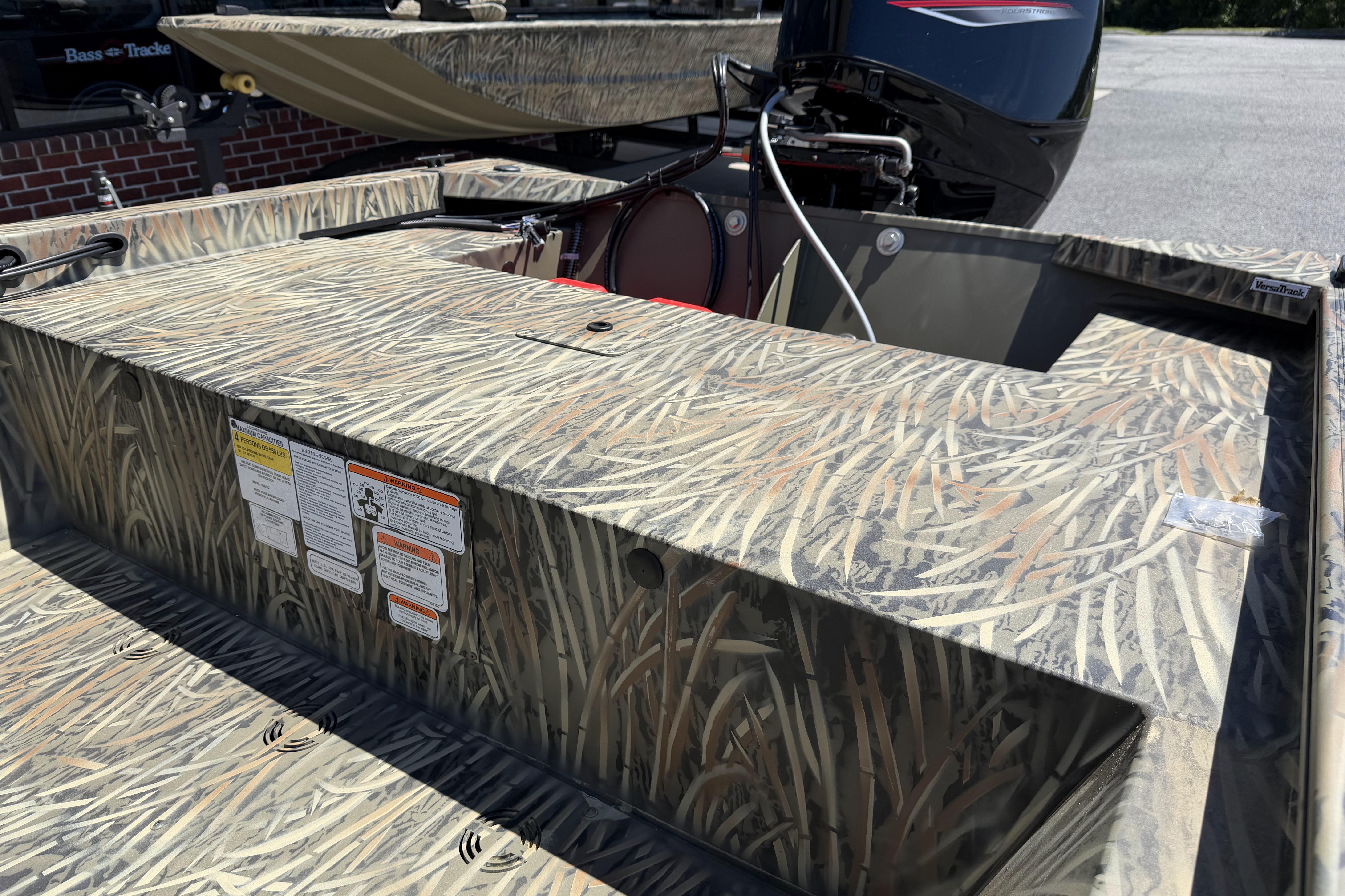 2026 Tracker Grizzly 1648 SC boat with camouflage design and outboard motor.