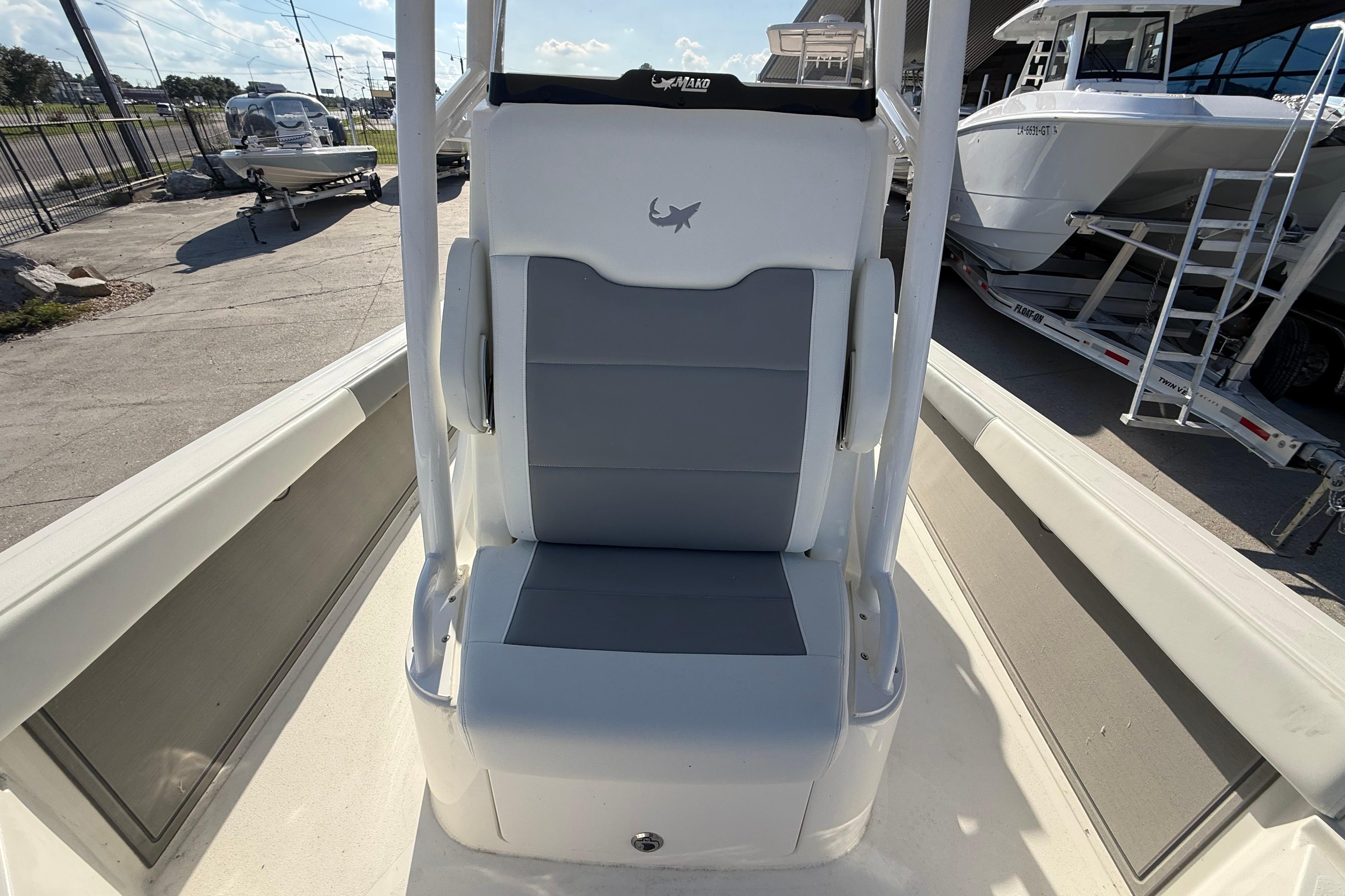 2026 Mako 24 APEX boat seat, gray and white design, outdoor display.