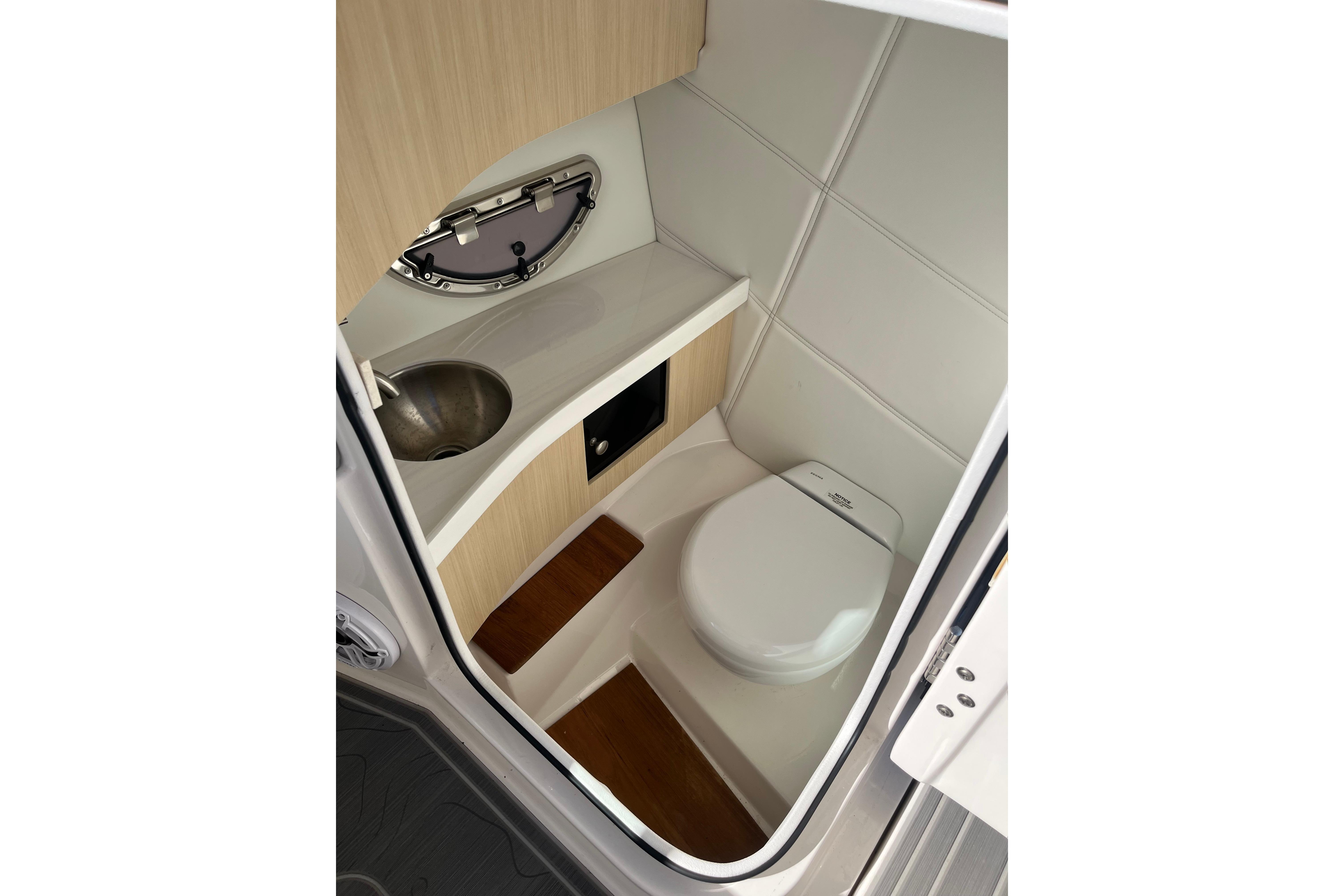 2024 Regal LS9 Surf boat interior bathroom with sink and toilet.