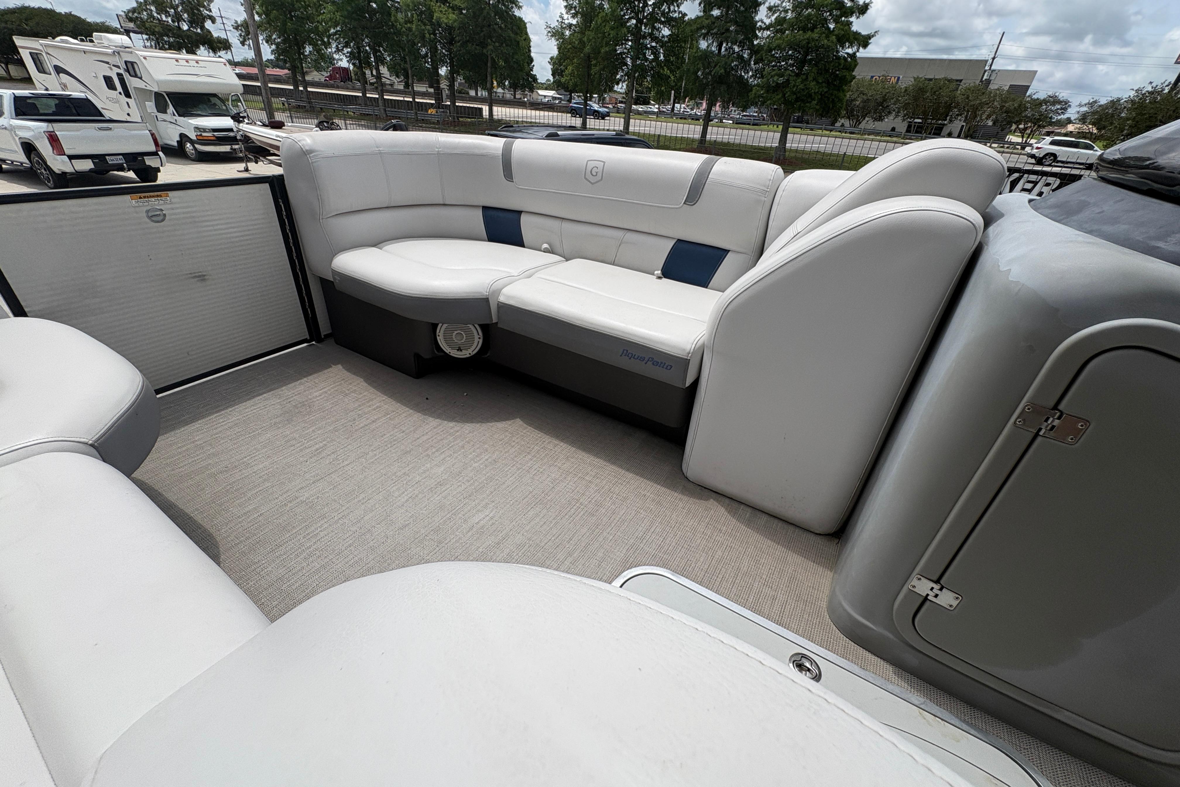 2019 Godfrey Aqua Patio boat interior with white seating and spacious layout.