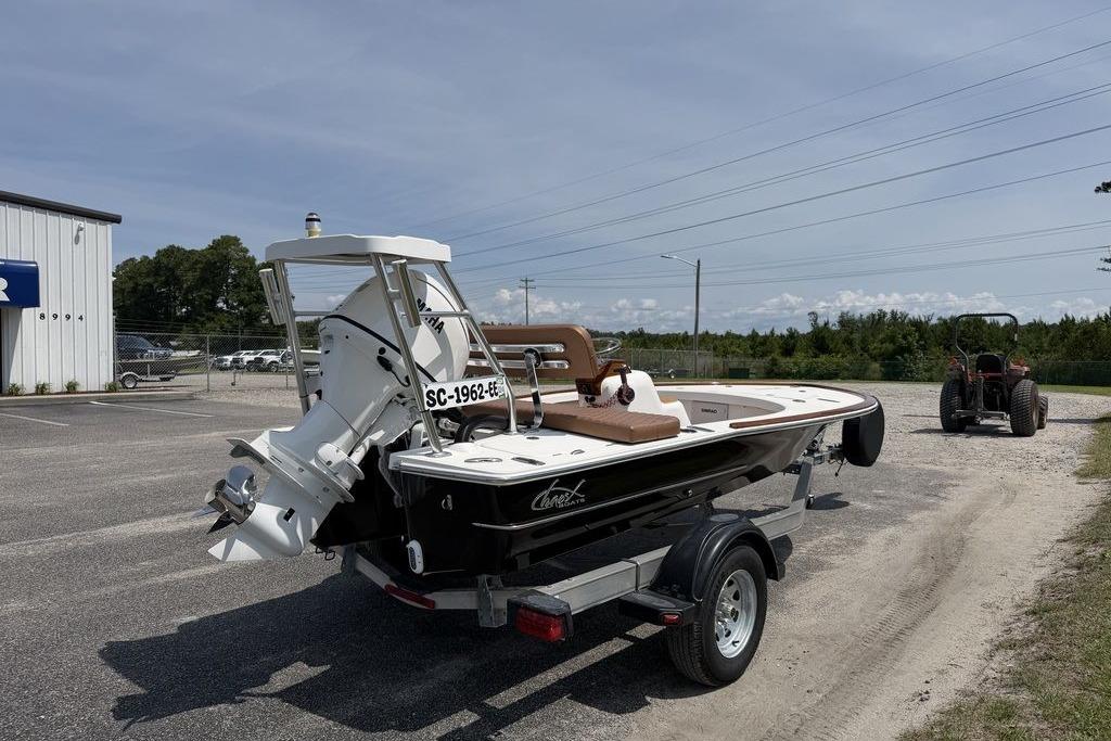 2012 Chaos 16 Bonefish boat on trailer, parked outdoors near a building and tractor.