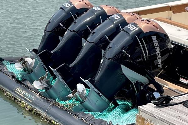 Four Mercury outboard engines on a 2020 Scout 420 LXF boat at a dock.
