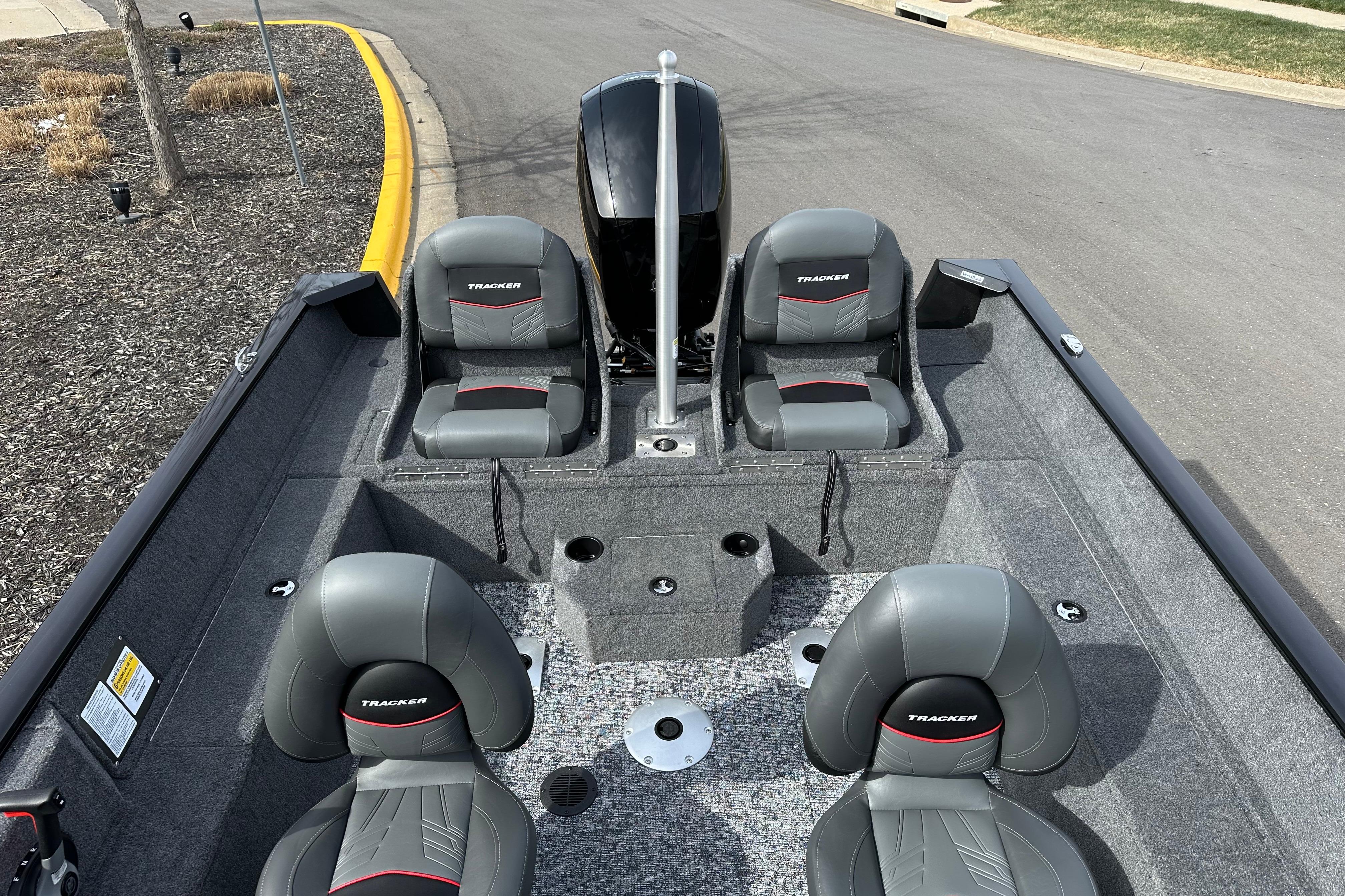 2026 Tracker Pro Guide V-175 Combo boat interior with four gray seats and motor.
