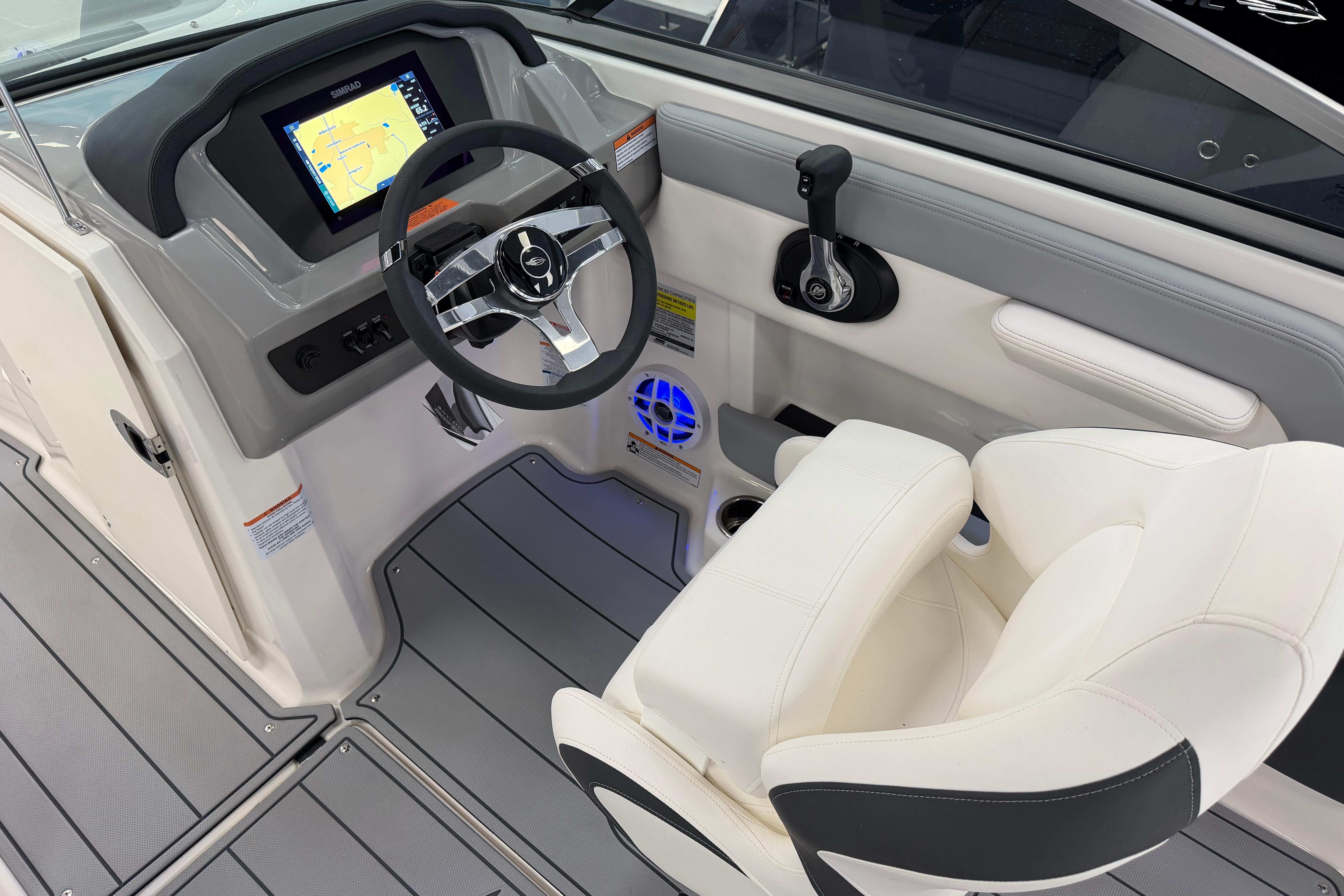 2025 Chaparral 21 SSi OB boat cockpit with modern steering and navigation display.