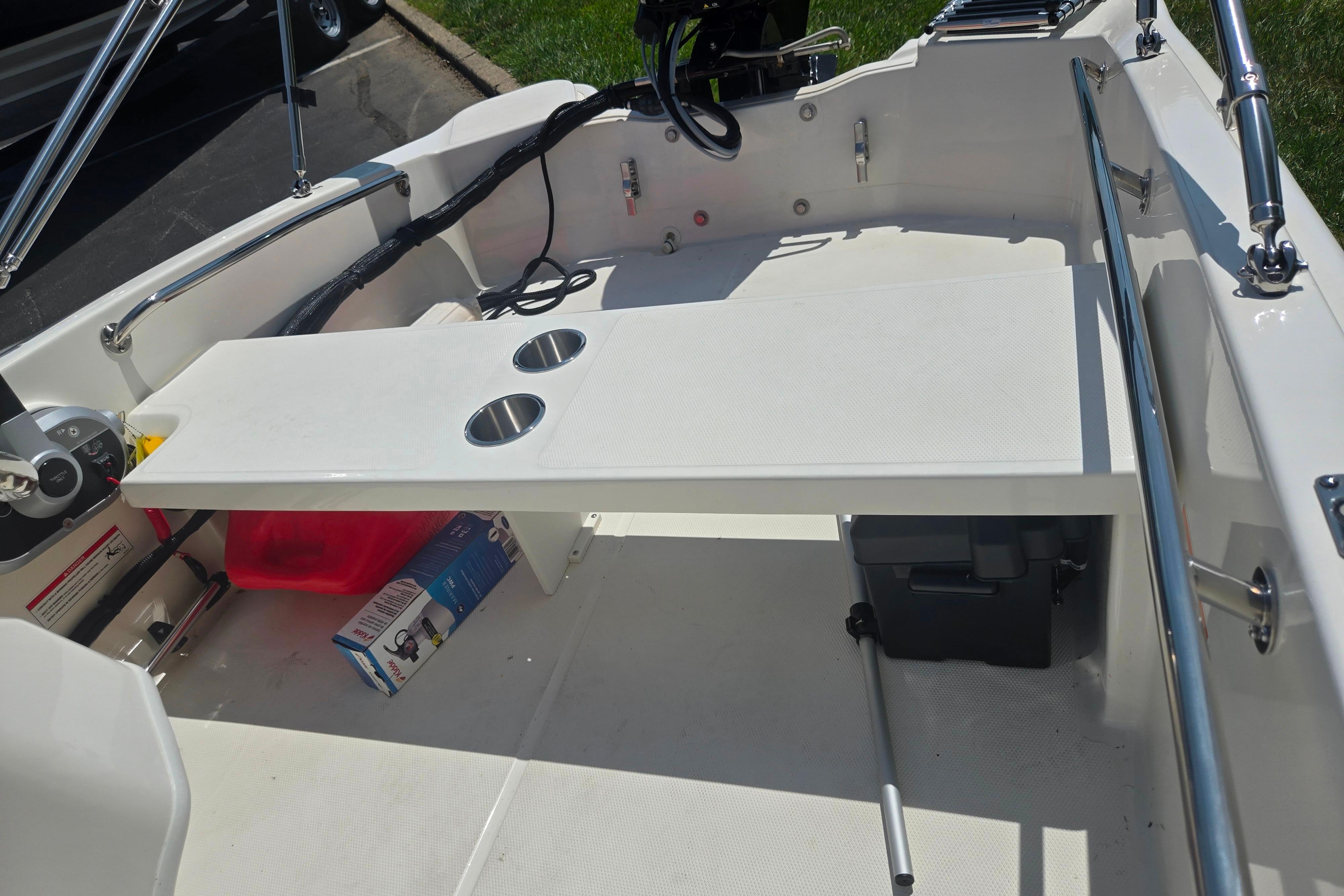 2025 Boston Whaler 130 Super Sport interior with table and cup holders.