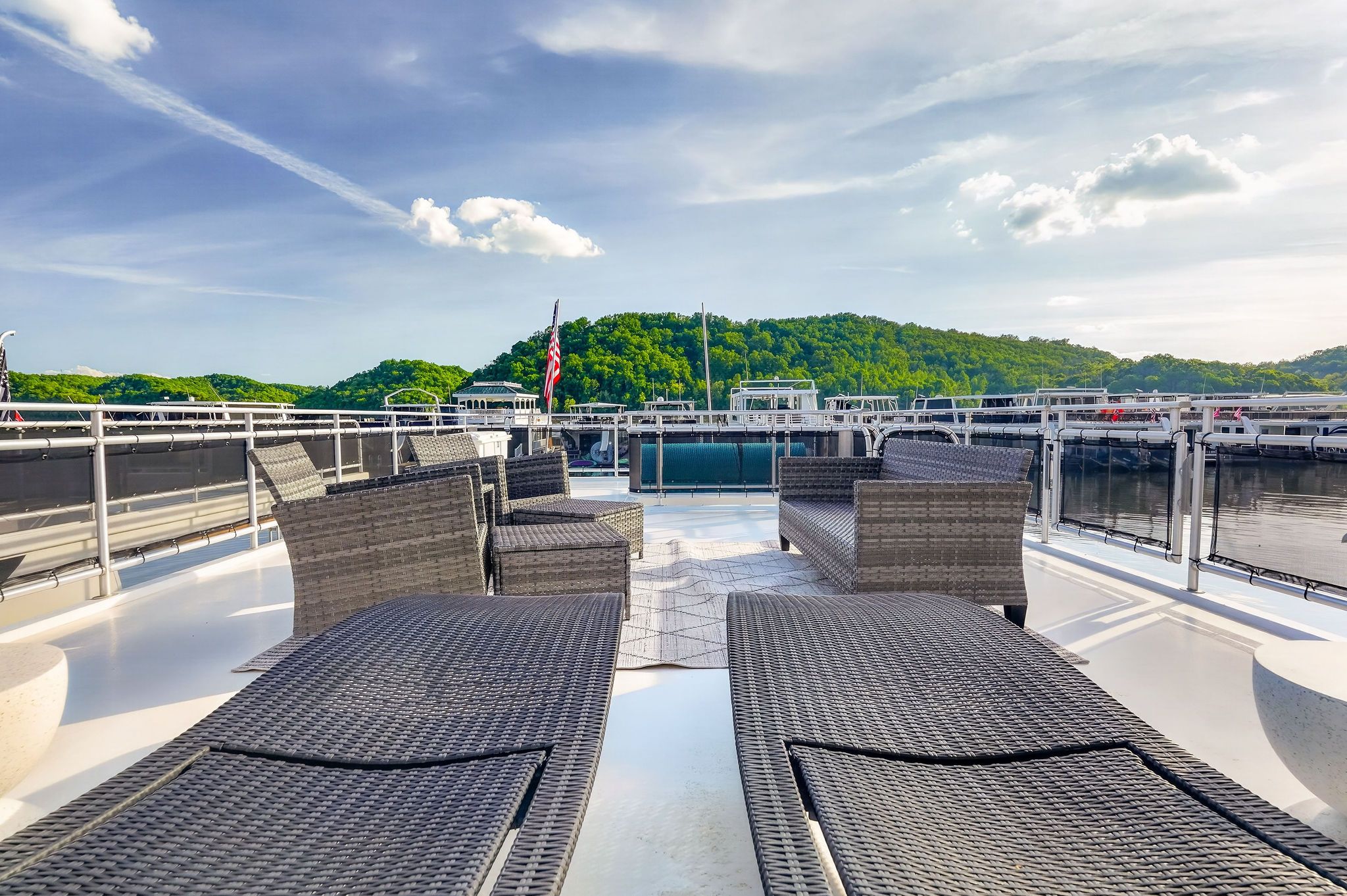 Houseboat deck with rattan furniture and scenic view, built in 2010.