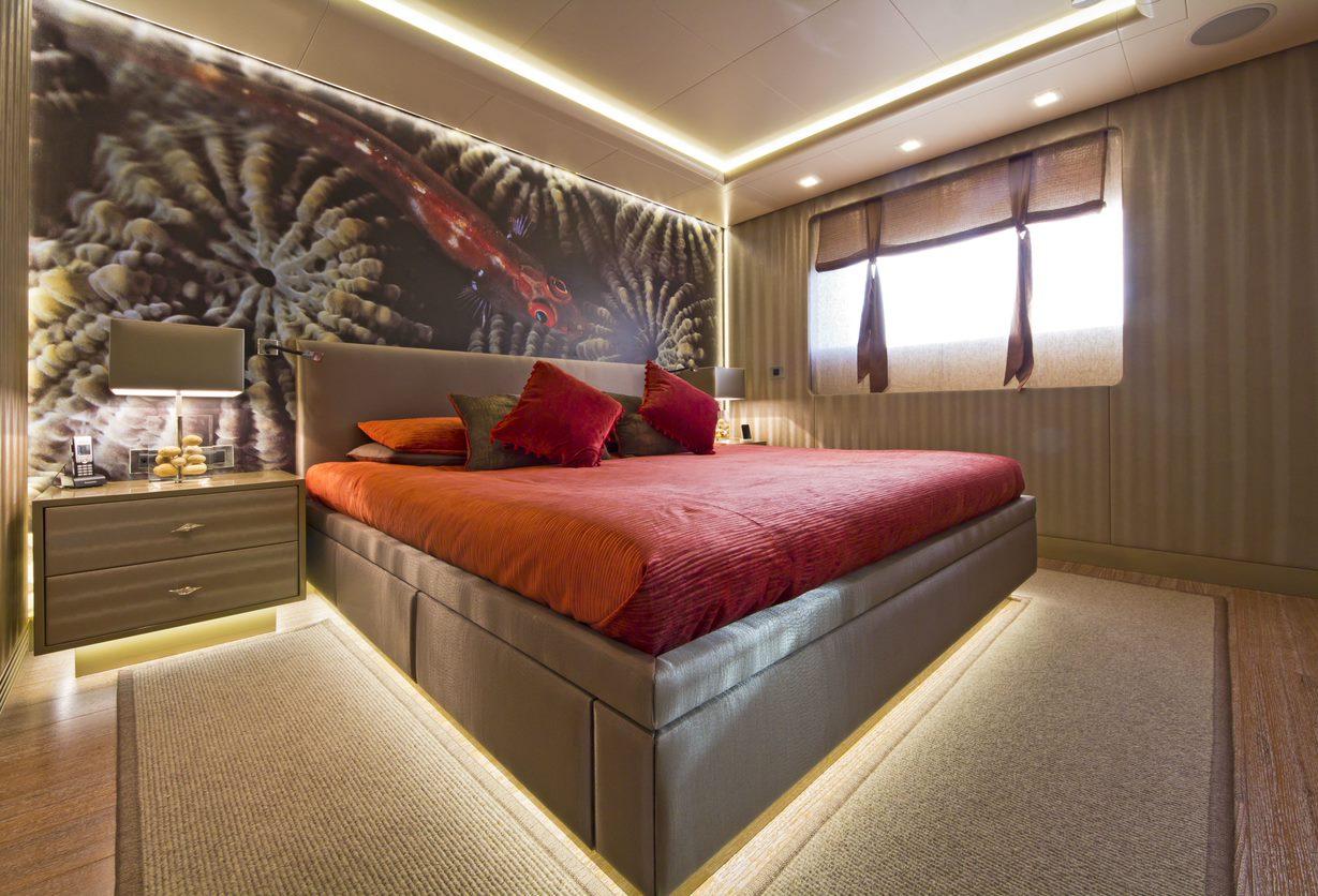 Luxurious bedroom with modern decor, featuring a large bed, ambient lighting, and artistic wall design.