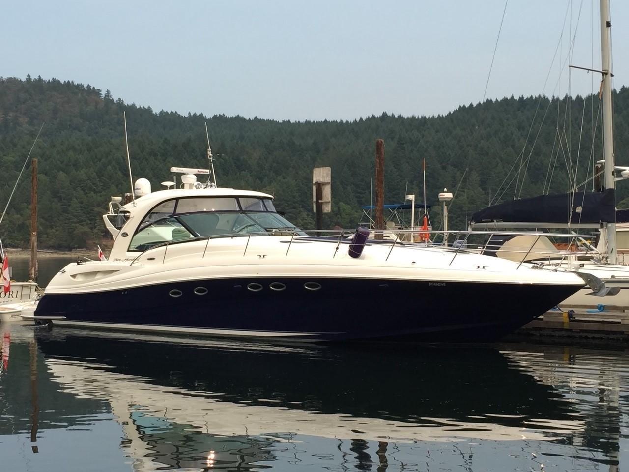 2005 Sea Ray 500 Sundancer yacht docked, surrounded by forest.