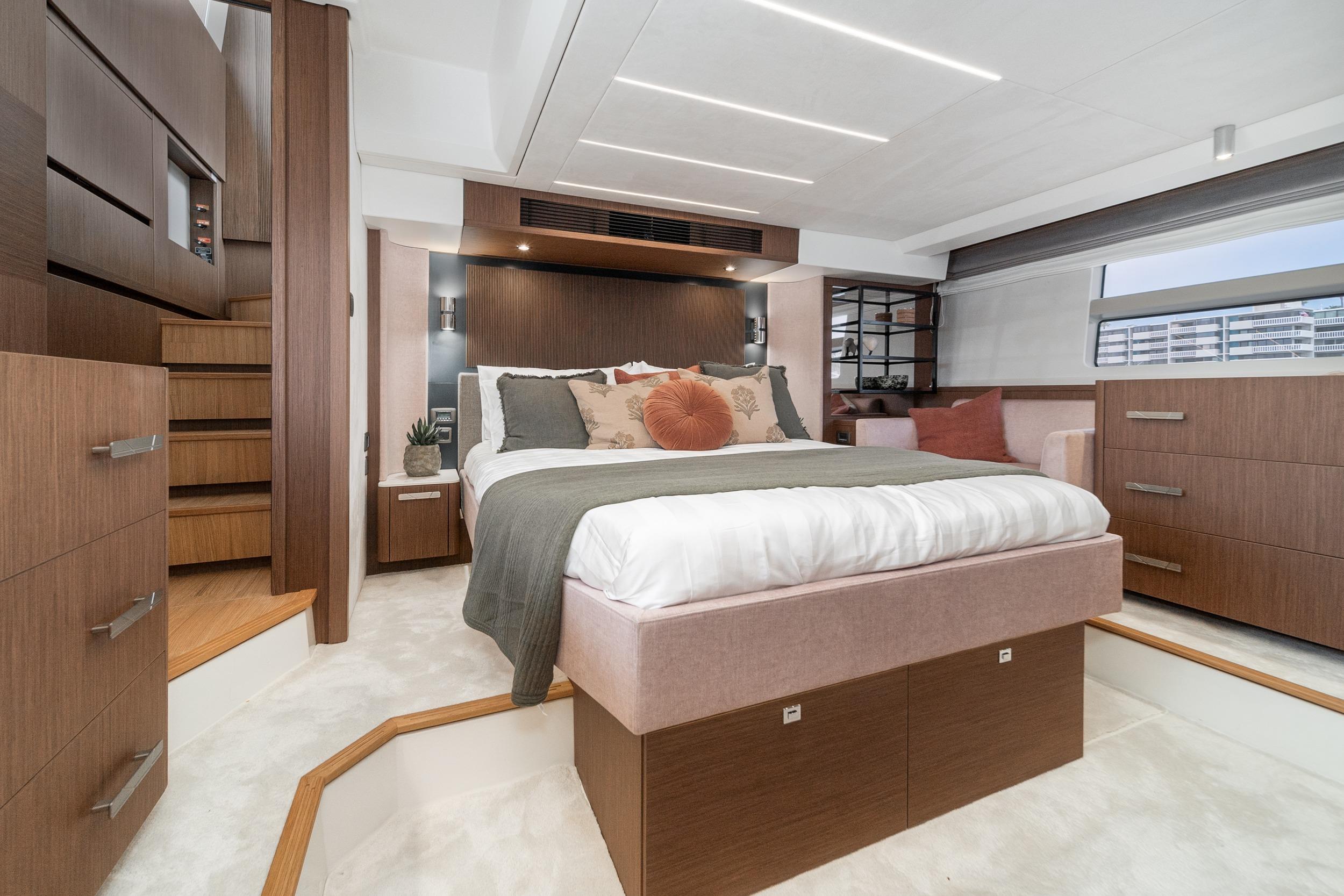 Luxurious 2024 Prestige X60 yacht bedroom with modern design and elegant wood finishes.