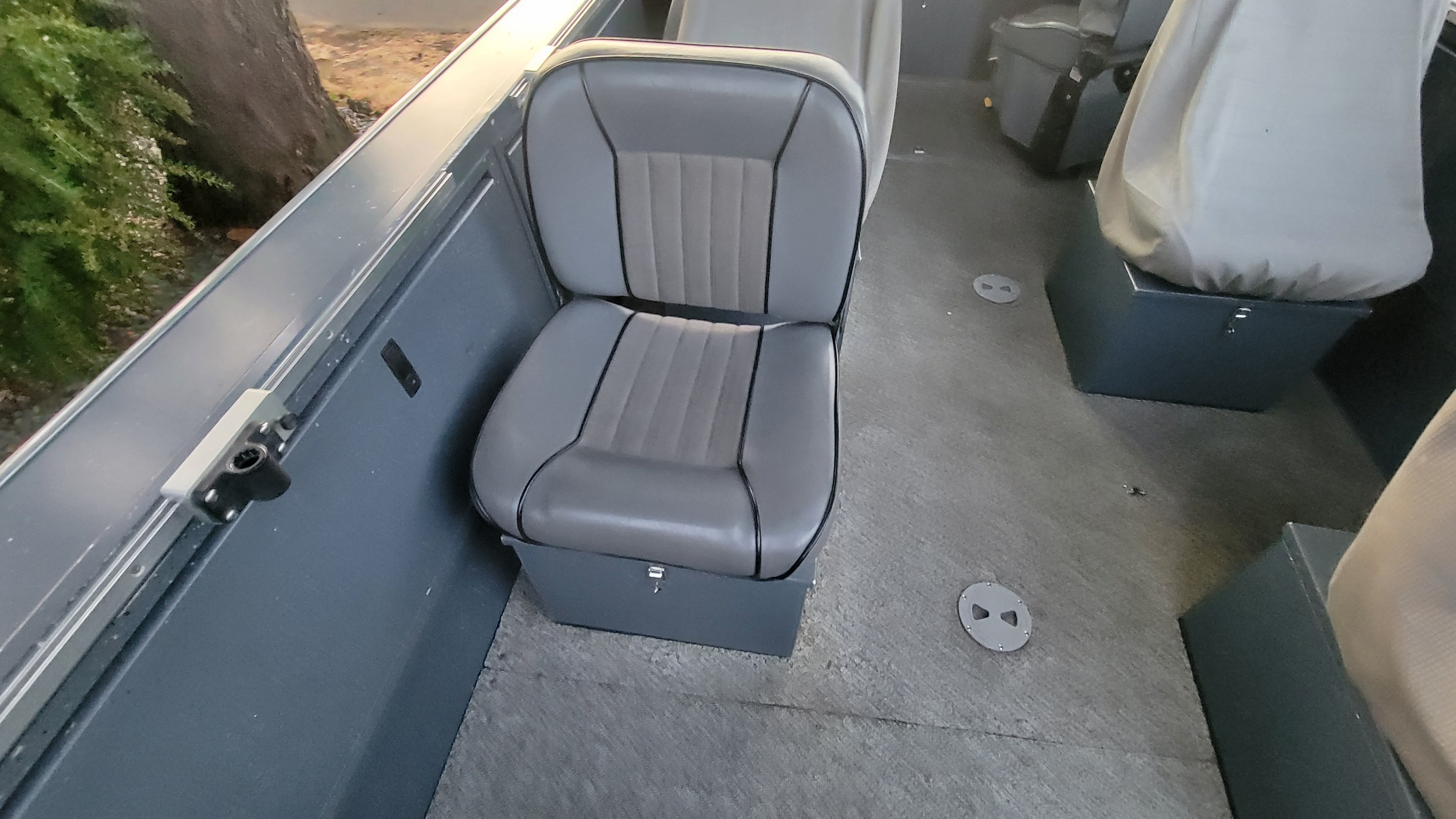 Interior of a 2015 Alumaweld Formula Vee Outboard 24 with gray seats and carpeted floor.