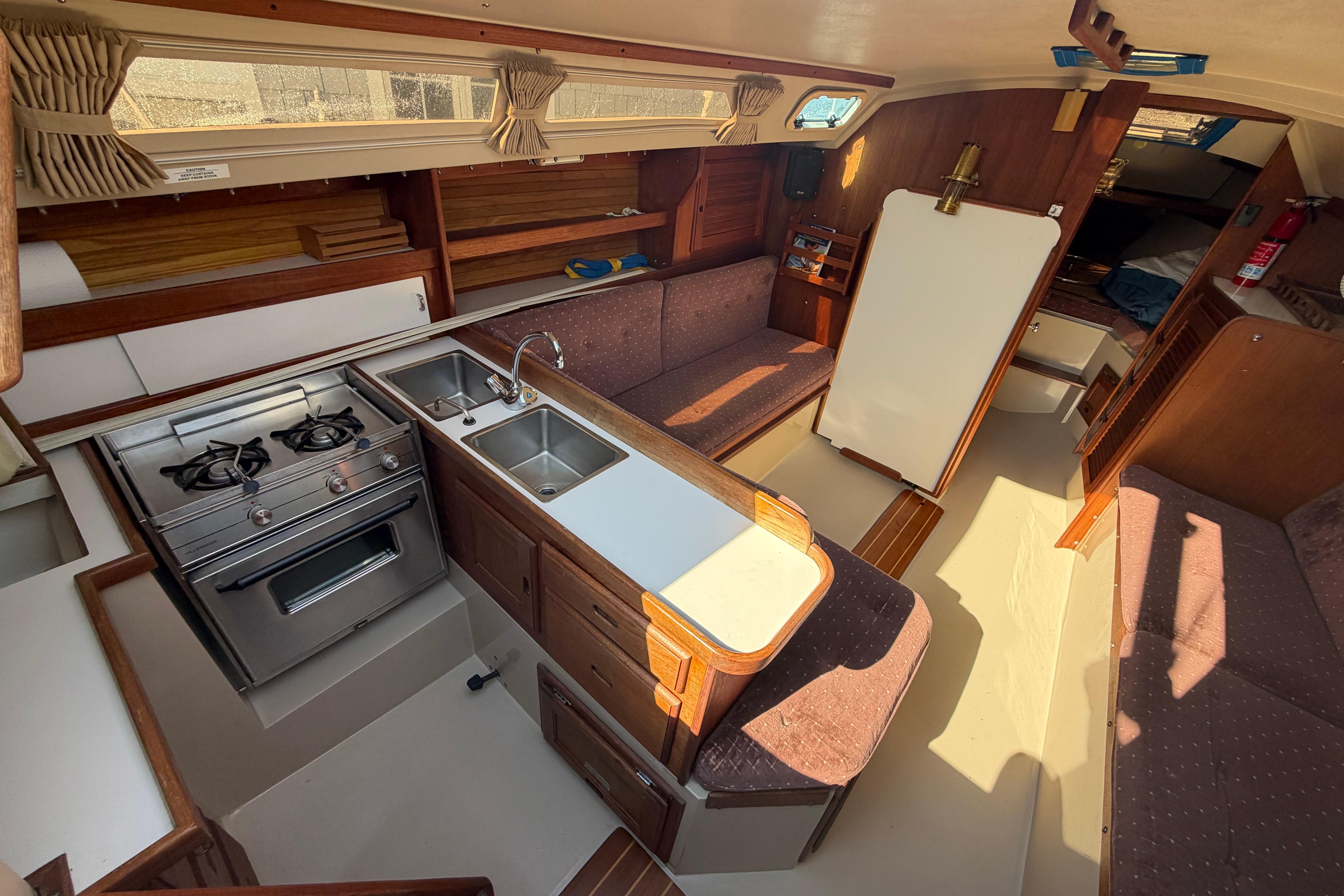 Interior of a 1988 Catalina 30 MkII sailboat with kitchen and seating area.